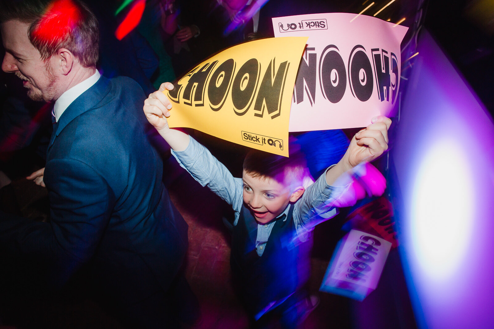 a kid holds up signs saying CHOON