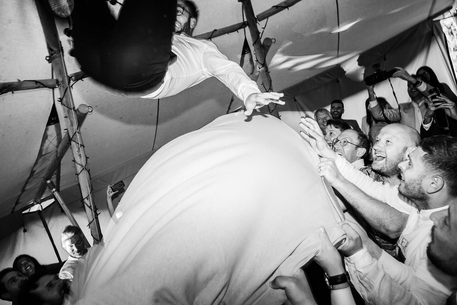 a groom flies through the air during jewish dancing at fforest wales