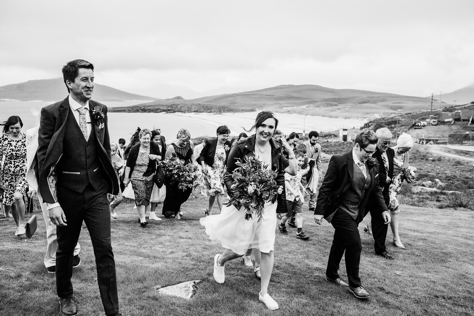 wedding party walks en masse from a group shot - Isle of harris scotland