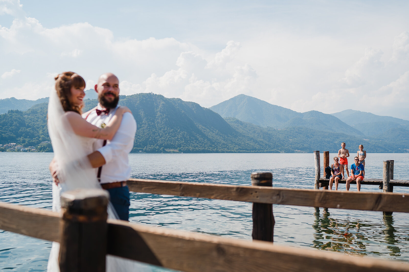 kids watch a bride and groom on lake orta Italy