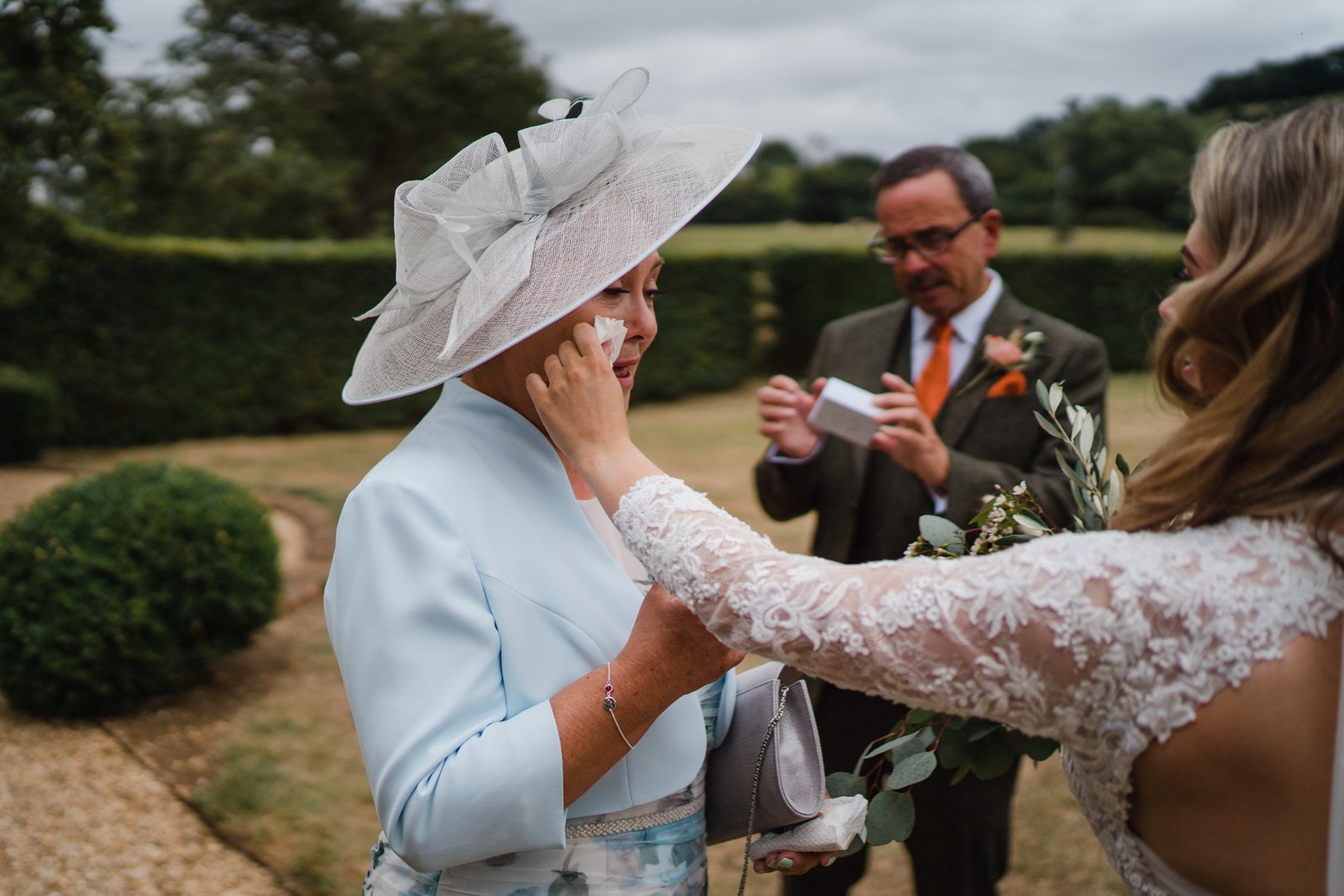 bride wipes away mums tears - 2022 wedding round up no nonsense heartfelt wedding photography leeallenphotos