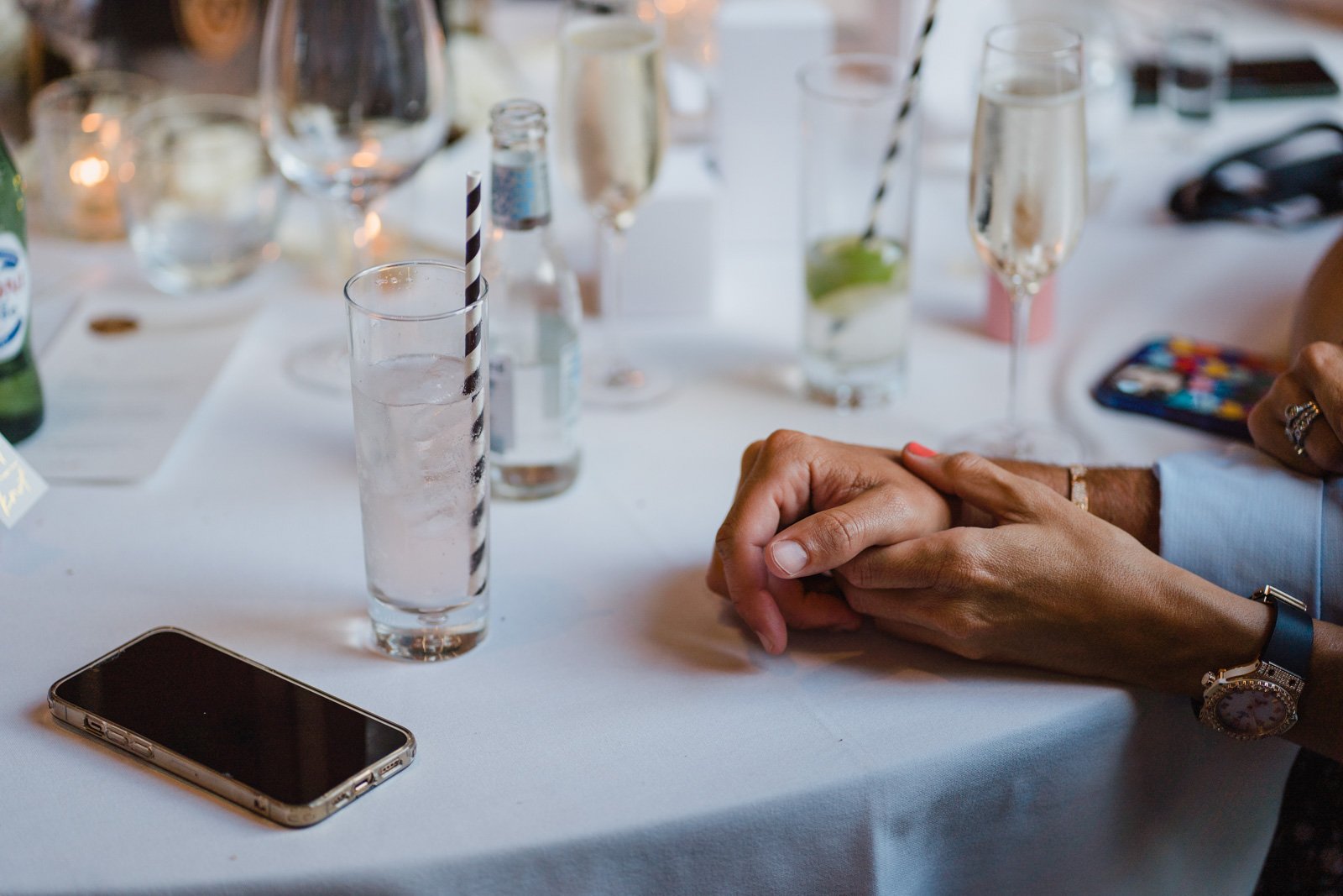 guests hands on a table - 2022 wedding round up no nonsense heartfelt wedding photography leeallenphotos