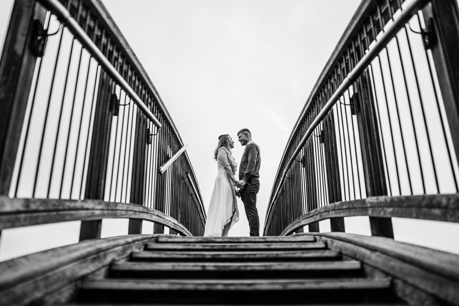 bride and groom kiss on a bridge - 2022 wedding round up no nonsense heartfelt wedding photography leeallenphotos