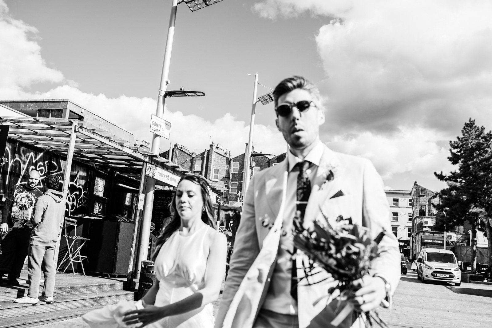 couple walk down a London street outside jones and soins - 2022 wedding round up no nonsense heartfelt wedding photography leeallenphotos