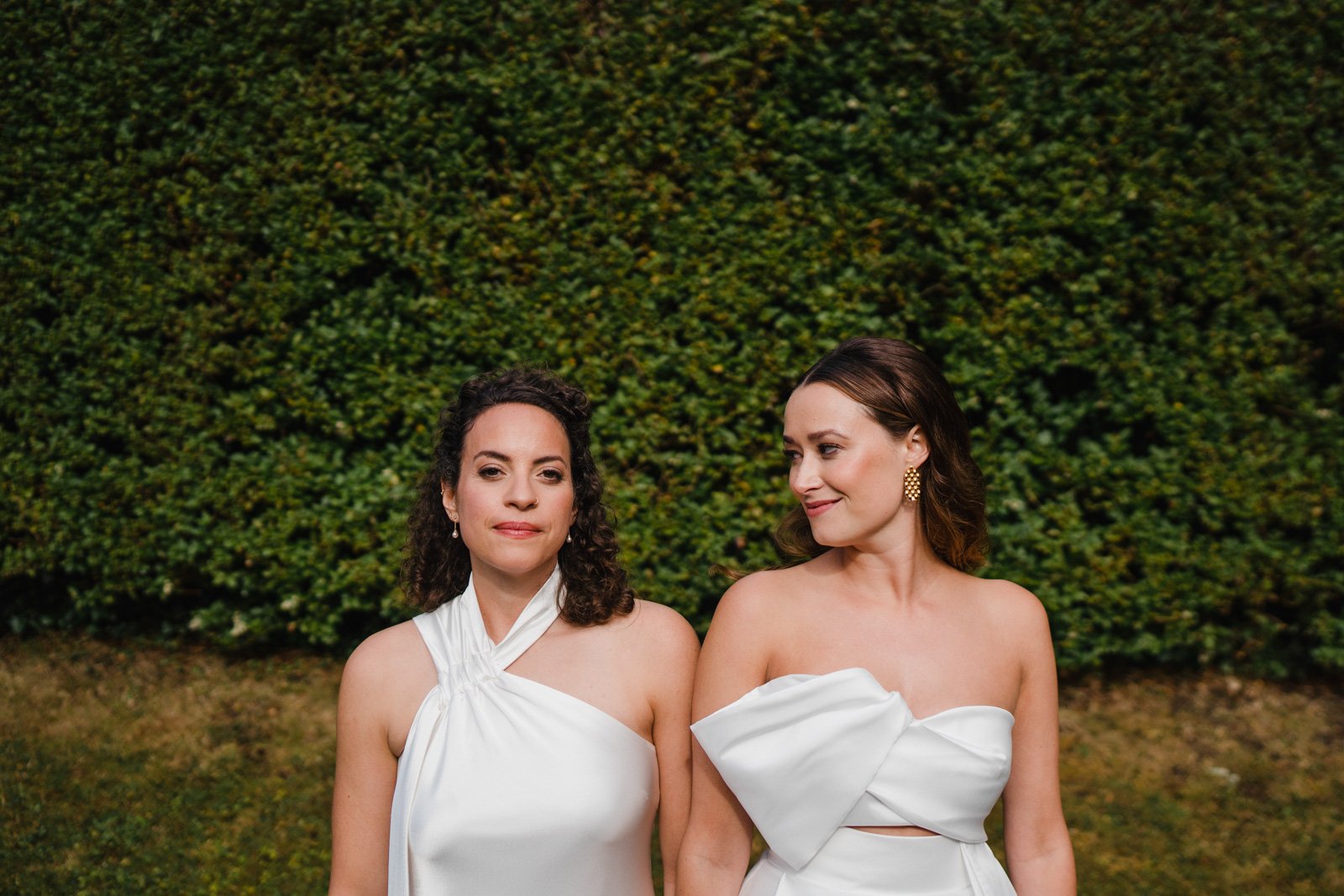 two brides pose in the sun - 2022 wedding round up no nonsense heartfelt wedding photography leeallenphotos