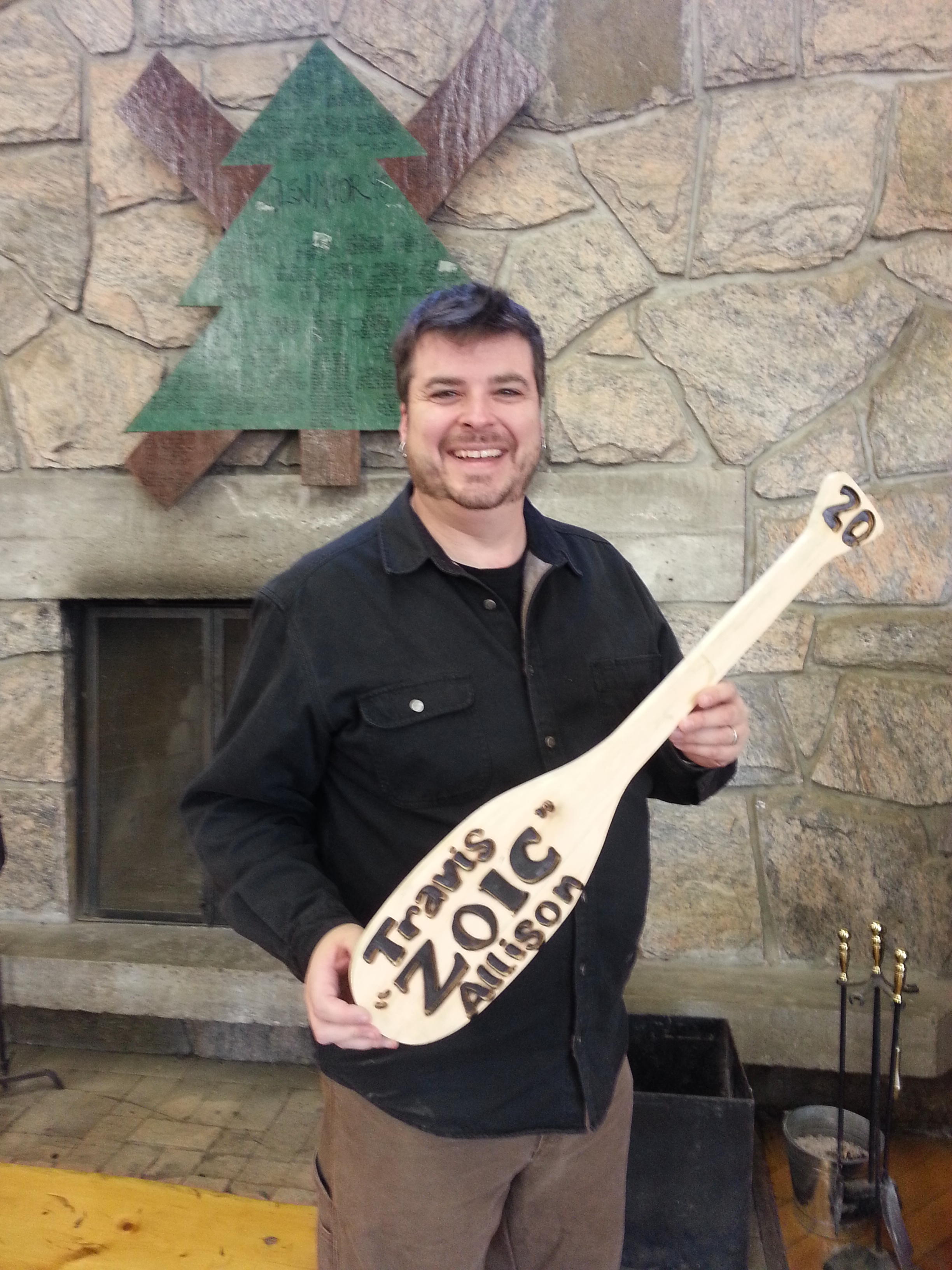 Travis Allison receives his 20 Year Paddle from Cairn