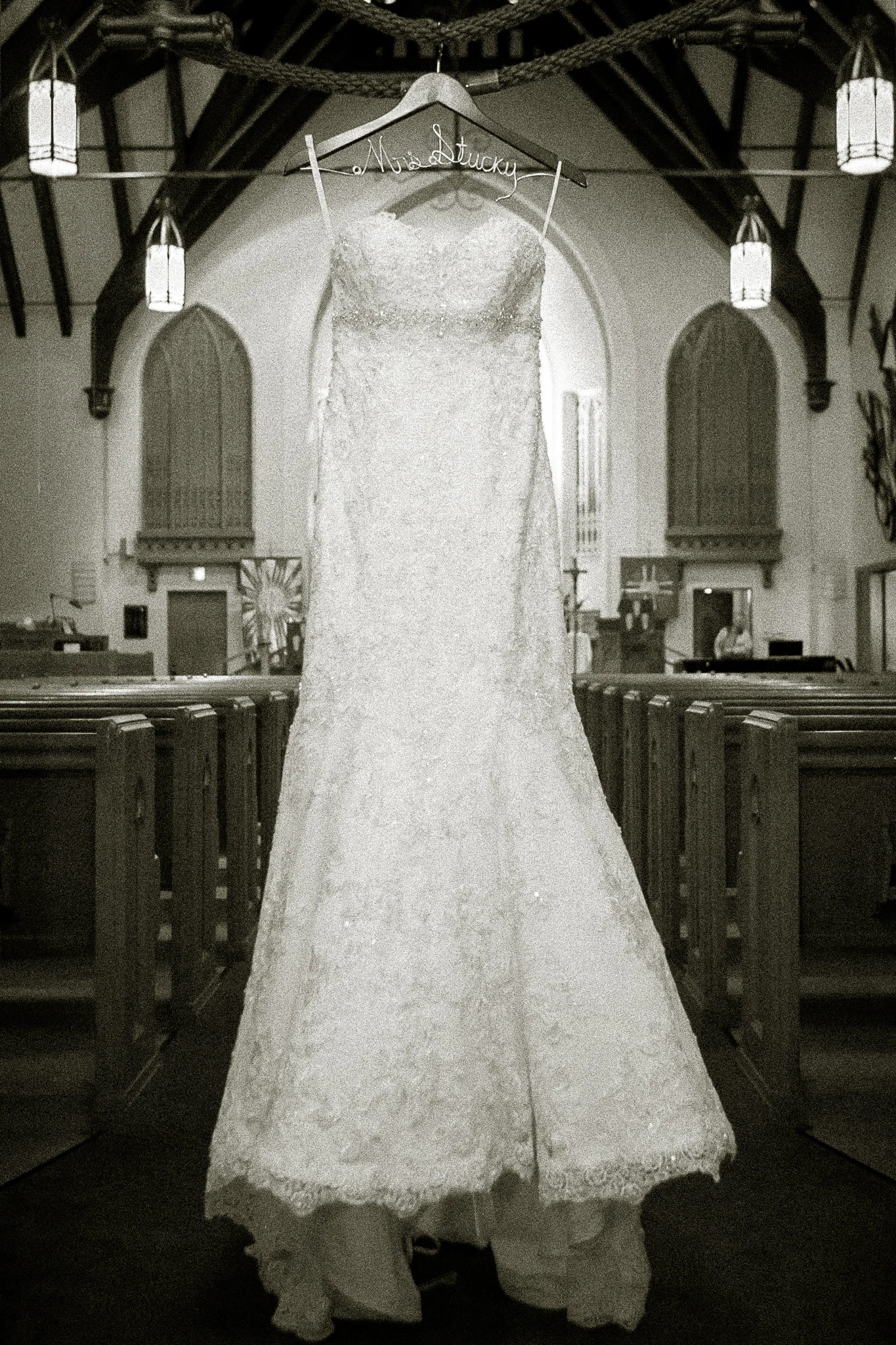 The wedding dress hanging at the entrance to the church sets the scene.