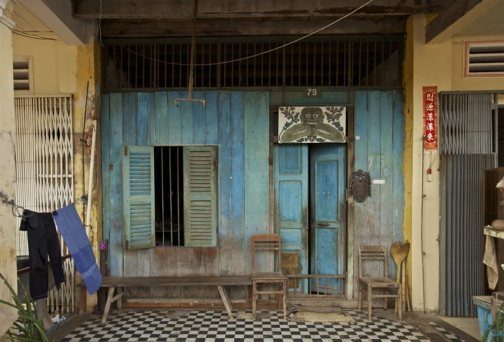 colorful house with traditional black pants and krama, cambodia's ever-present scarf, drying in the breeze