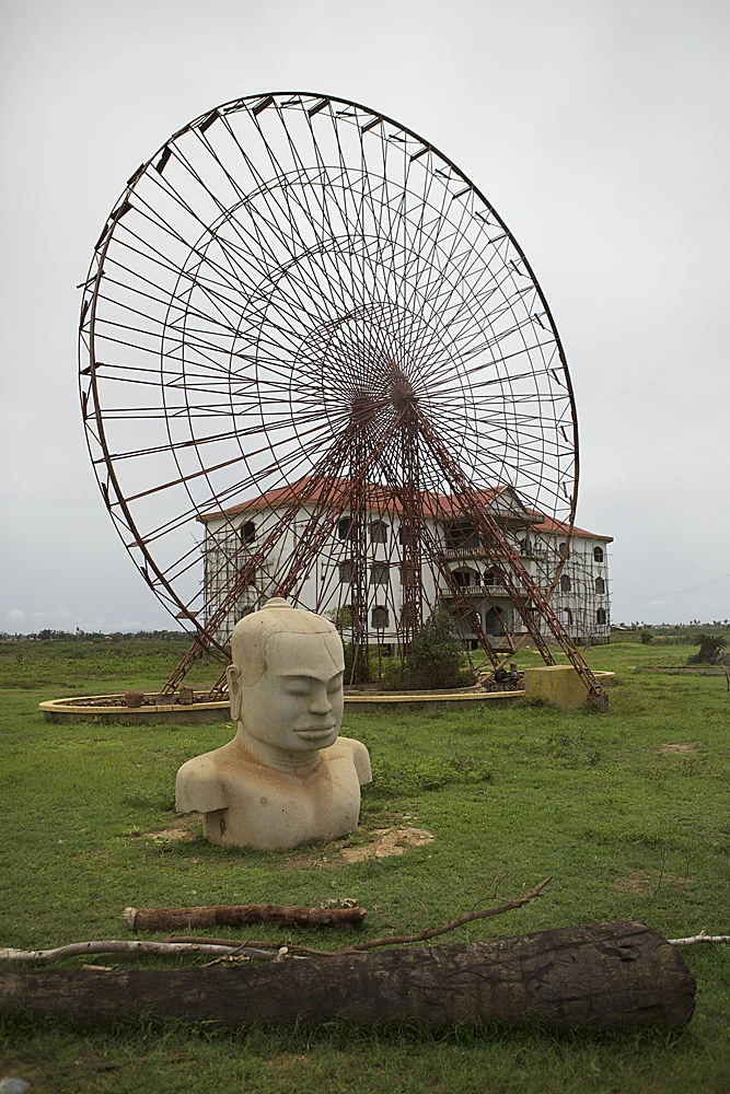 a bust of khmer king jayavarthuna sits in front of an abandoned construction project near oudong, a popular weekend destination outside phnom penh
