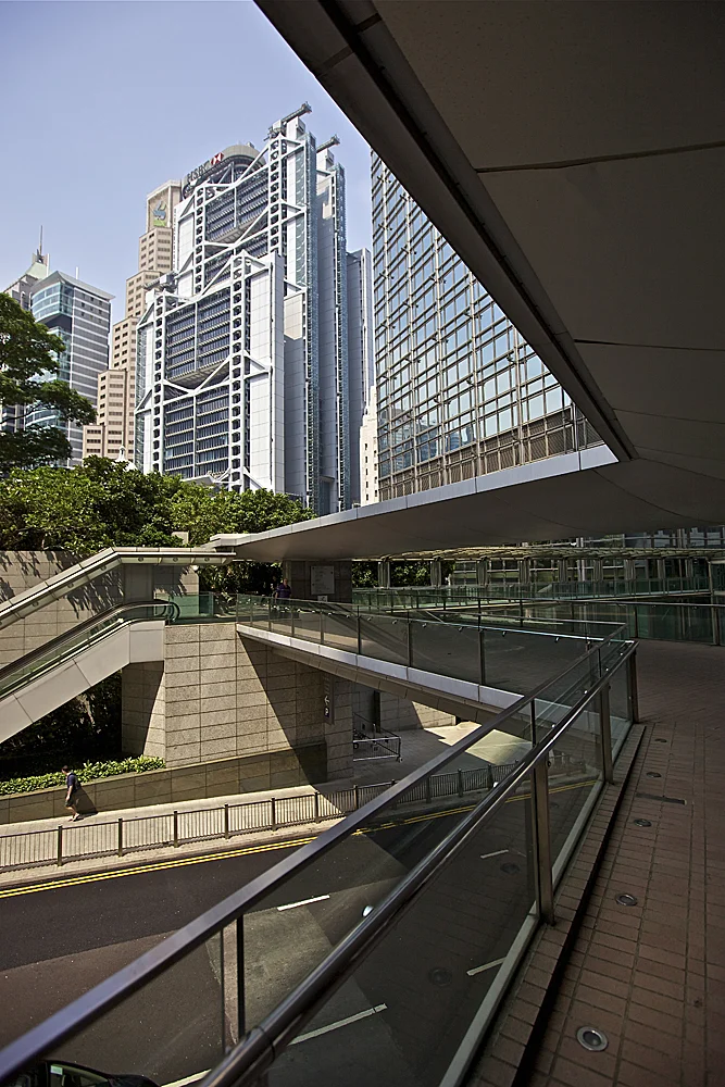 over and under: the iconic hsbc building looms over the roads and pedestrian overpasses in central hong kong