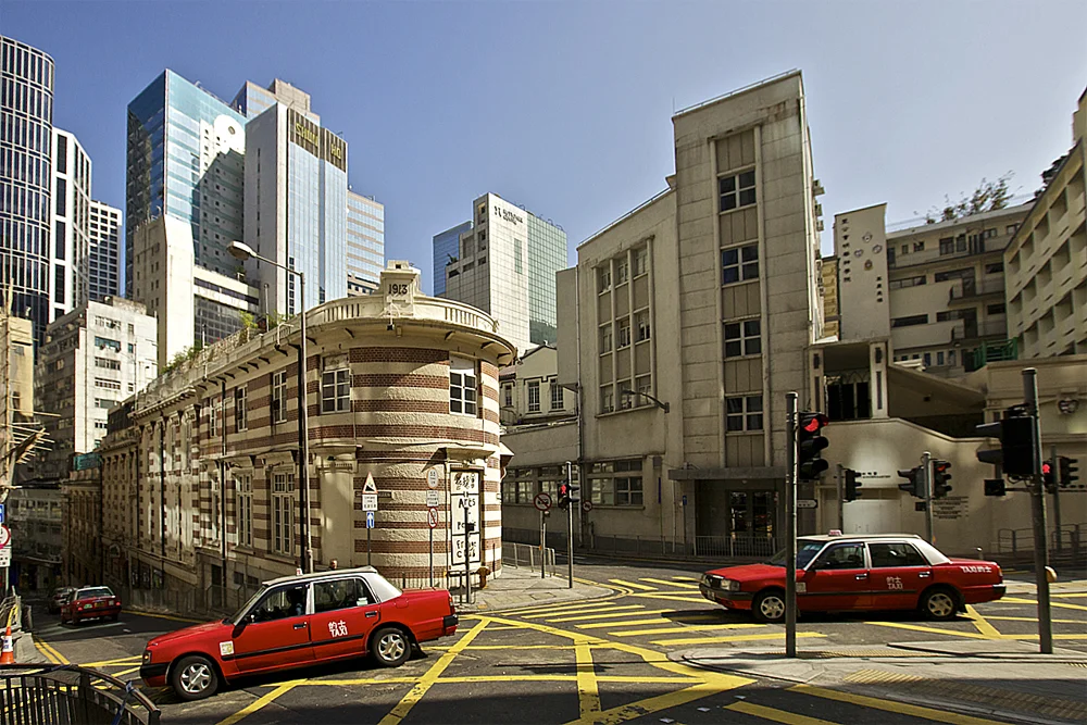 hong kong taxis drive past a mix of modern and colonial architecture in central hong kong