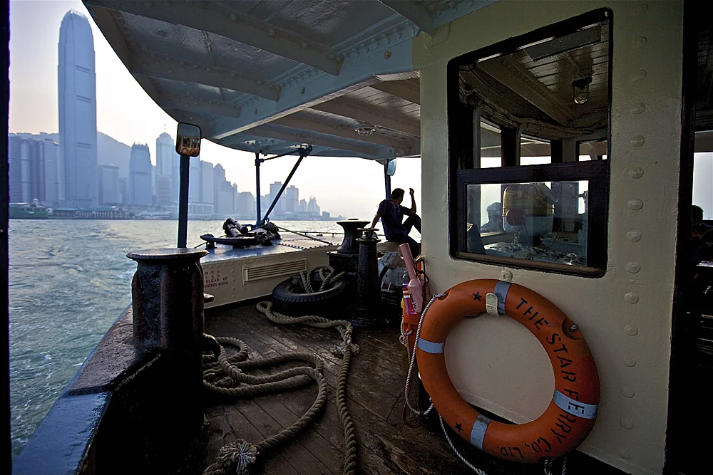 a moment to reflect on the star ferry as it heads towards the 1 IFC building in central hong kong