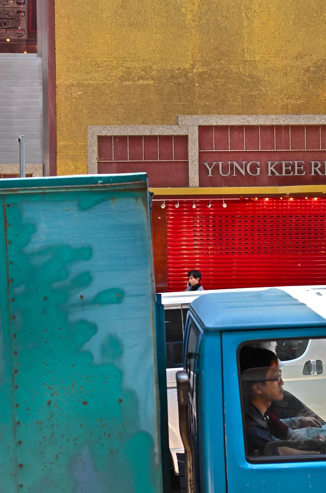 hong kong traffic and store fronts create abstract color blocks