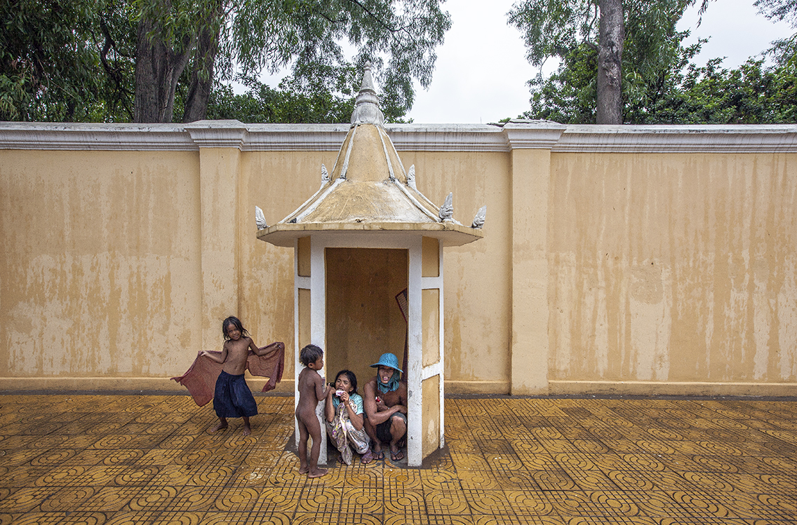 shelter from the rains outside the royal palace in central phnom penh