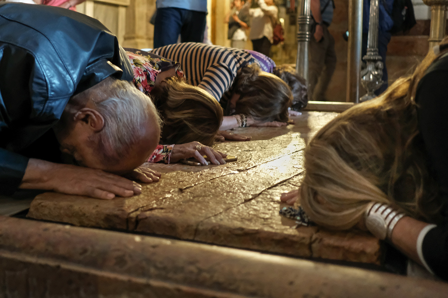  Christian pilgrims at the Stone of Anointing, Jerusalem, where Jesus’ body is said to have been prepared for burial.  