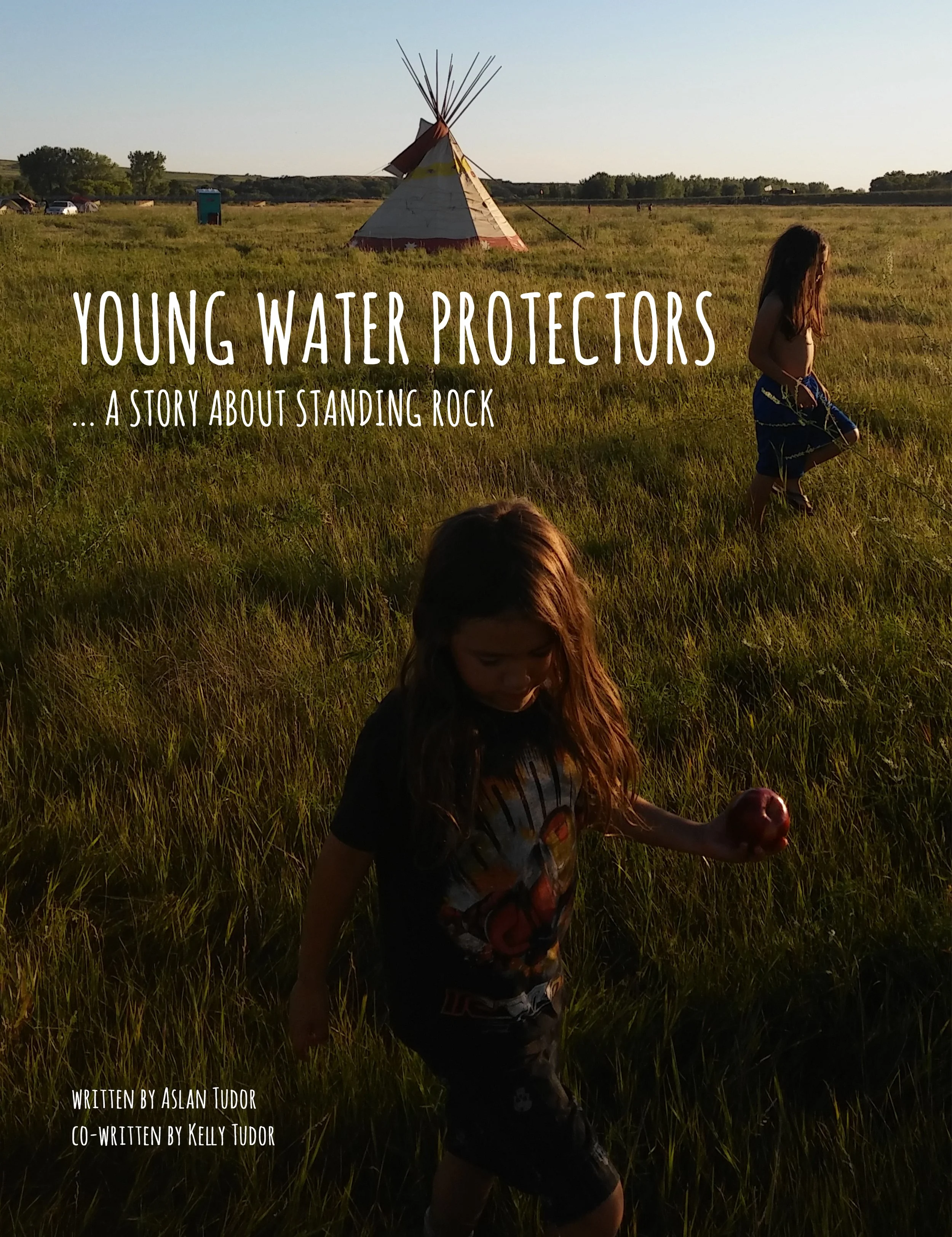 Children walking in a grassy field near a tipi with "Young Water Protectors: A Story About Standing Rock" text overlay.