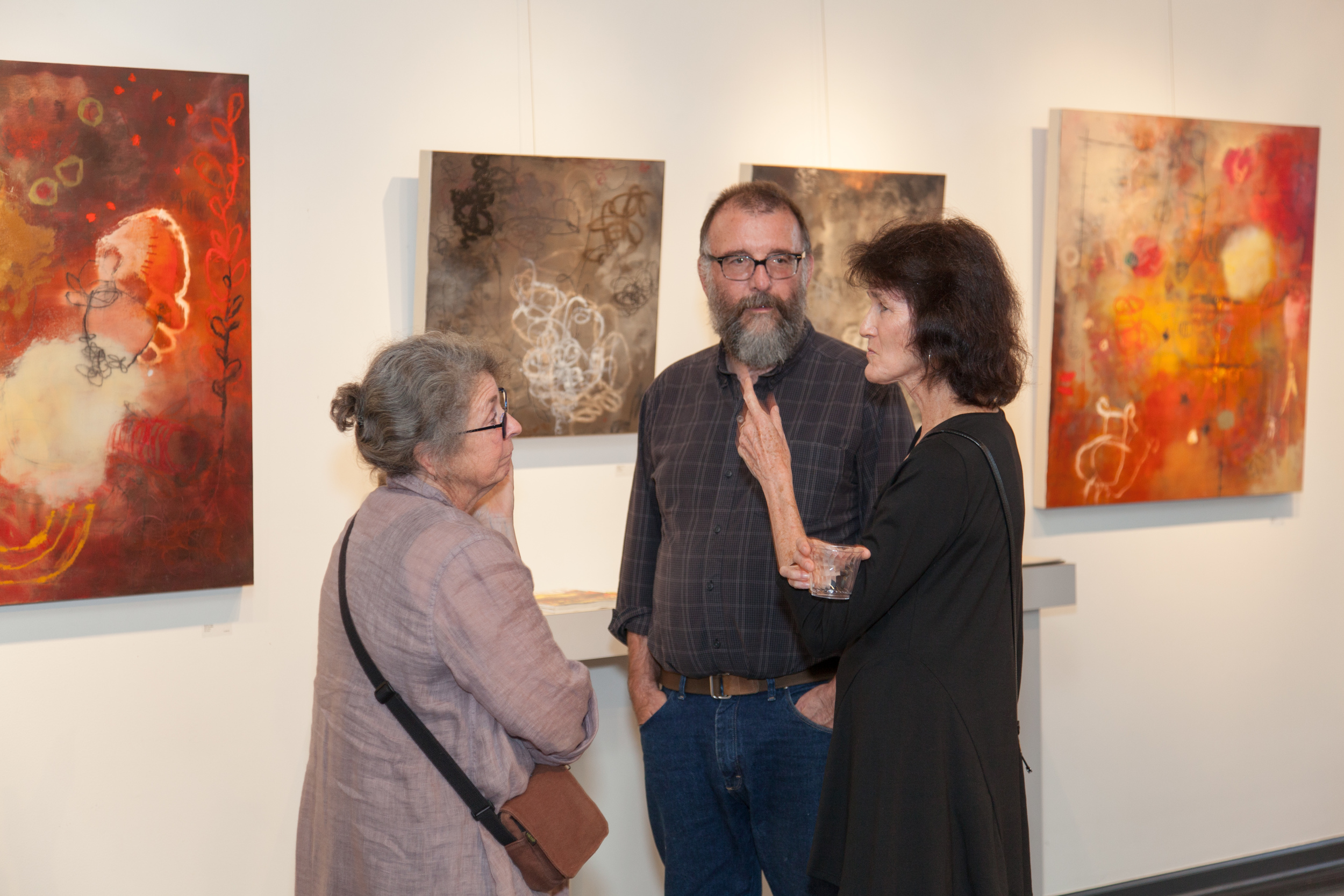 painter b arbara Fisher with her works cause and effect, restless, approaching storm and what's in Front of you. 
