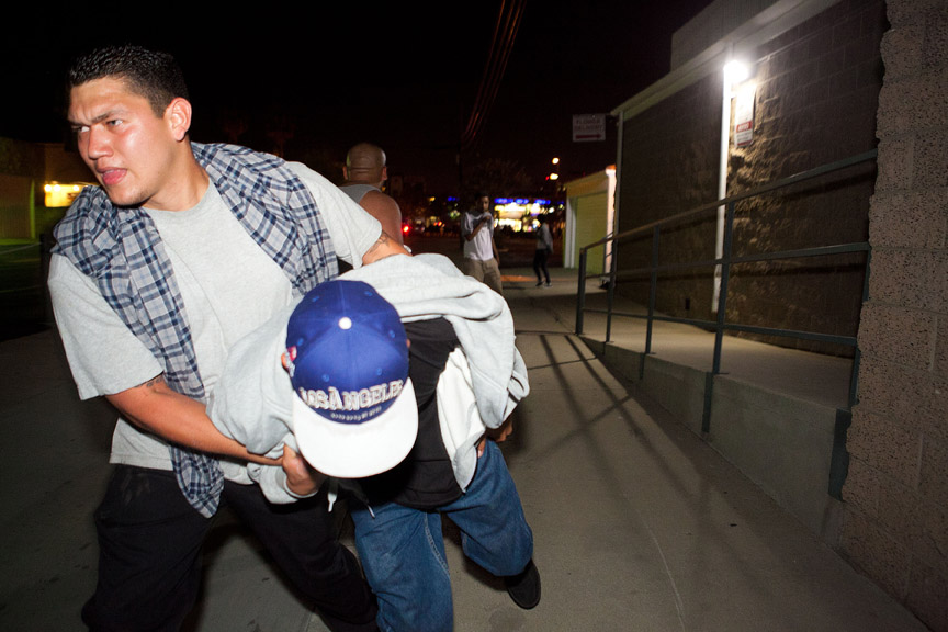  A protester is rushed away after being struck by rubber bullets fired by Orange County Police Officers.&nbsp;  