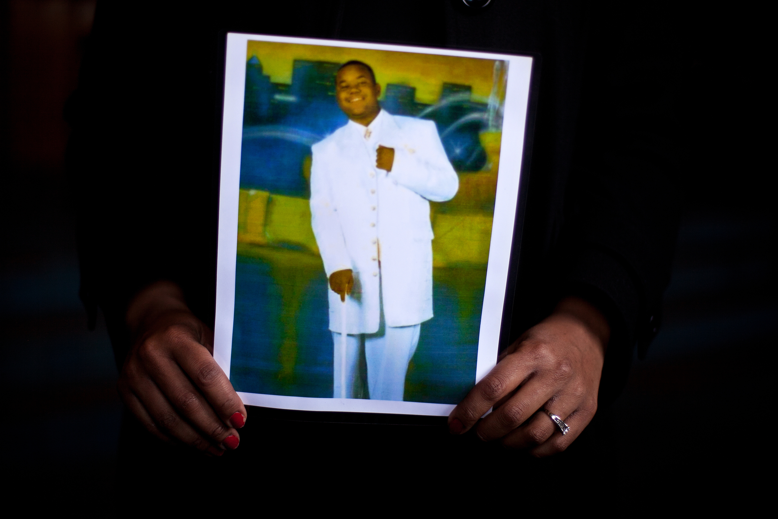  Pamela Bosley grips a laminated, 8-by-10 photograph of her late son, Terrell. The photo was taken at his high school prom, less than a year before his death. 