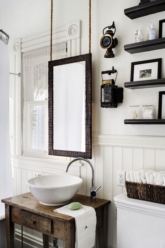 This is a perfect example. This window was disguised with paint. It blends into the wall painted the same color. Then the high contrast in the mirror, cabinet and shelving draws your eye. 