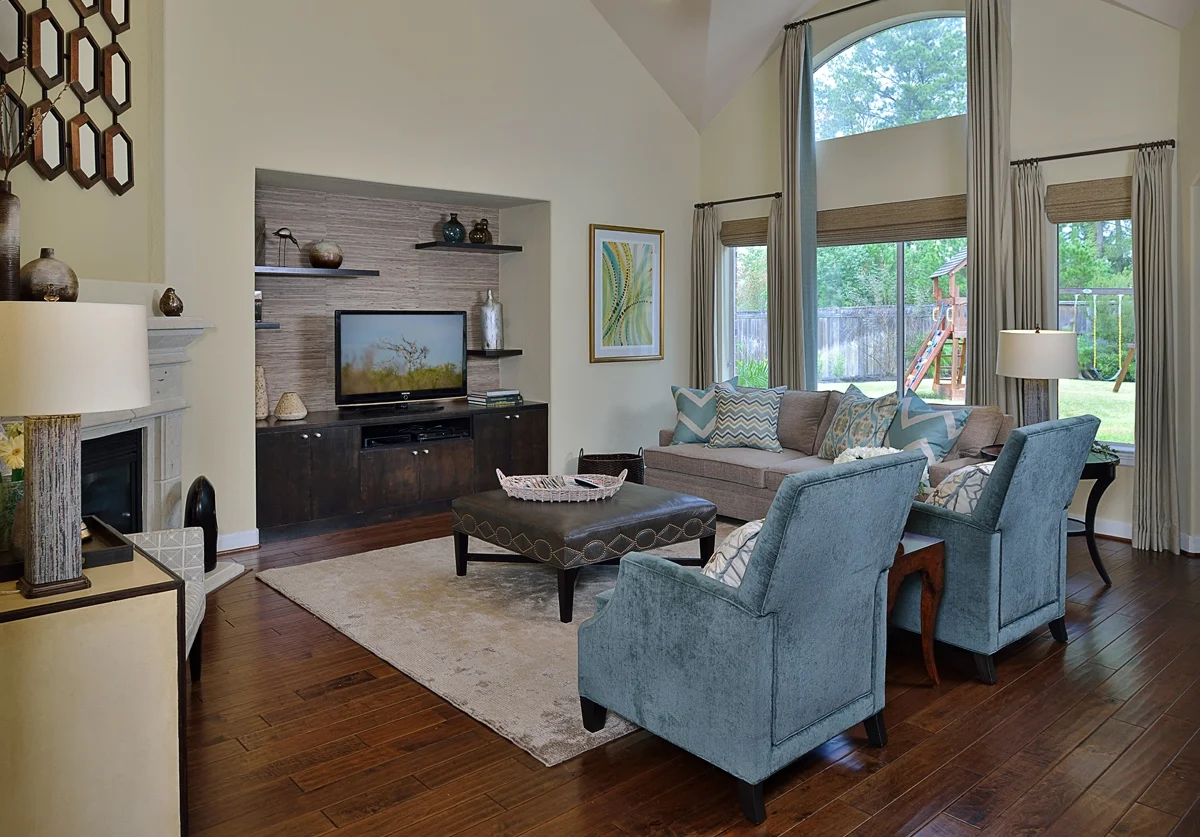 Furnishings, a new built-in entertainment center, and some finishing touches helped complete this living room designed by Carla Aston, giving a young family a clean, contemporary look with colorful accents and fresh style that compliments personality perfectly.