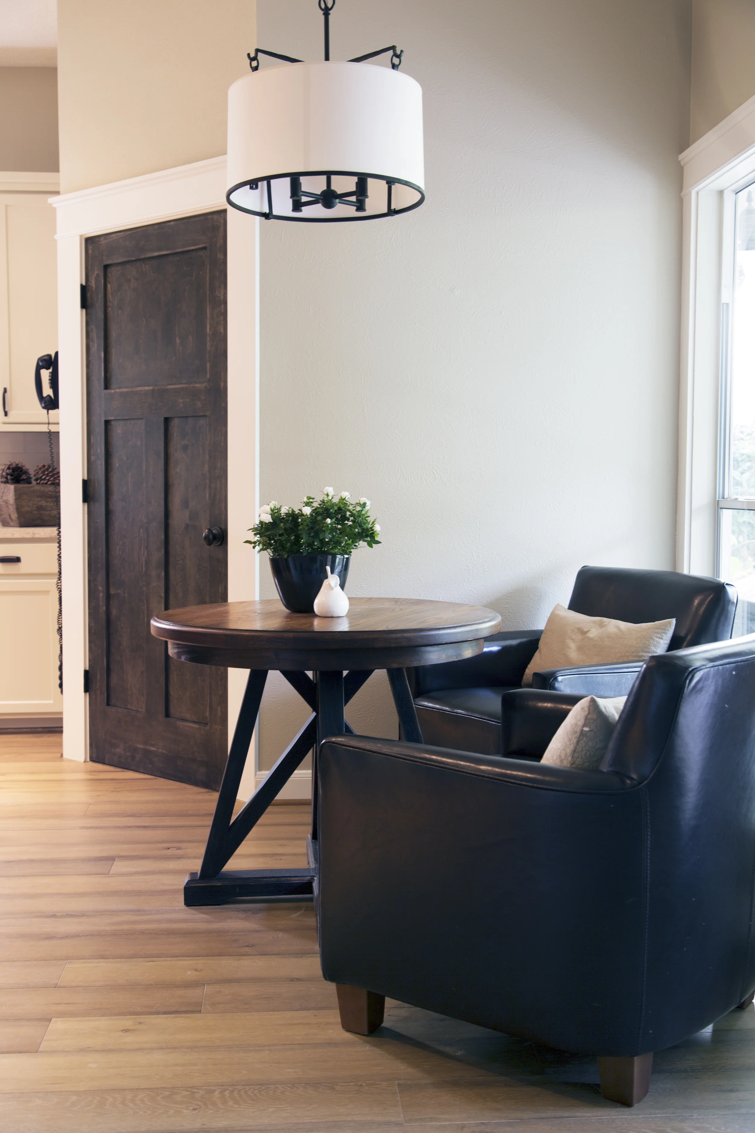 Interior design -ed by Carla Aston, interior designer / Photography by Tori Aston | Home kitchen renovation-remodel-makeover; rustic, coffee house style; leather chair; wood floor; table.