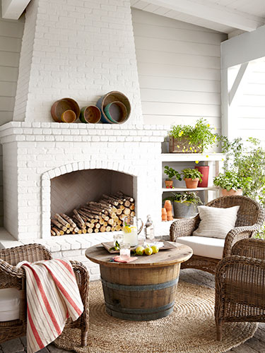 Outdoor mantel decorated with baskets. | Interior Designer: Victoria Pearson