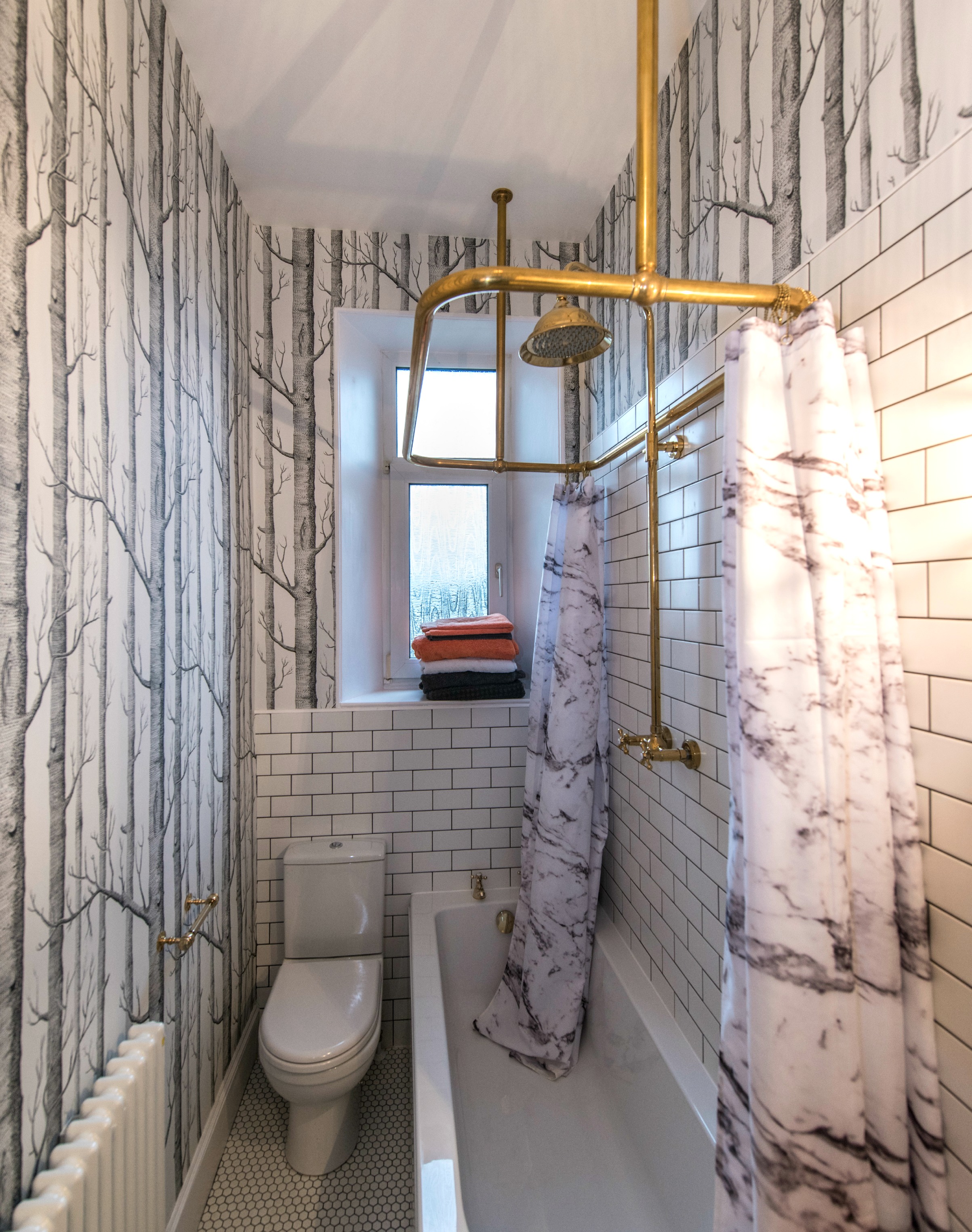 bathroom remodel; mirror; toilet; tile floor; shower; lighting; sink; wall art | Apartment remodeled by: Deborah Peterson Milne