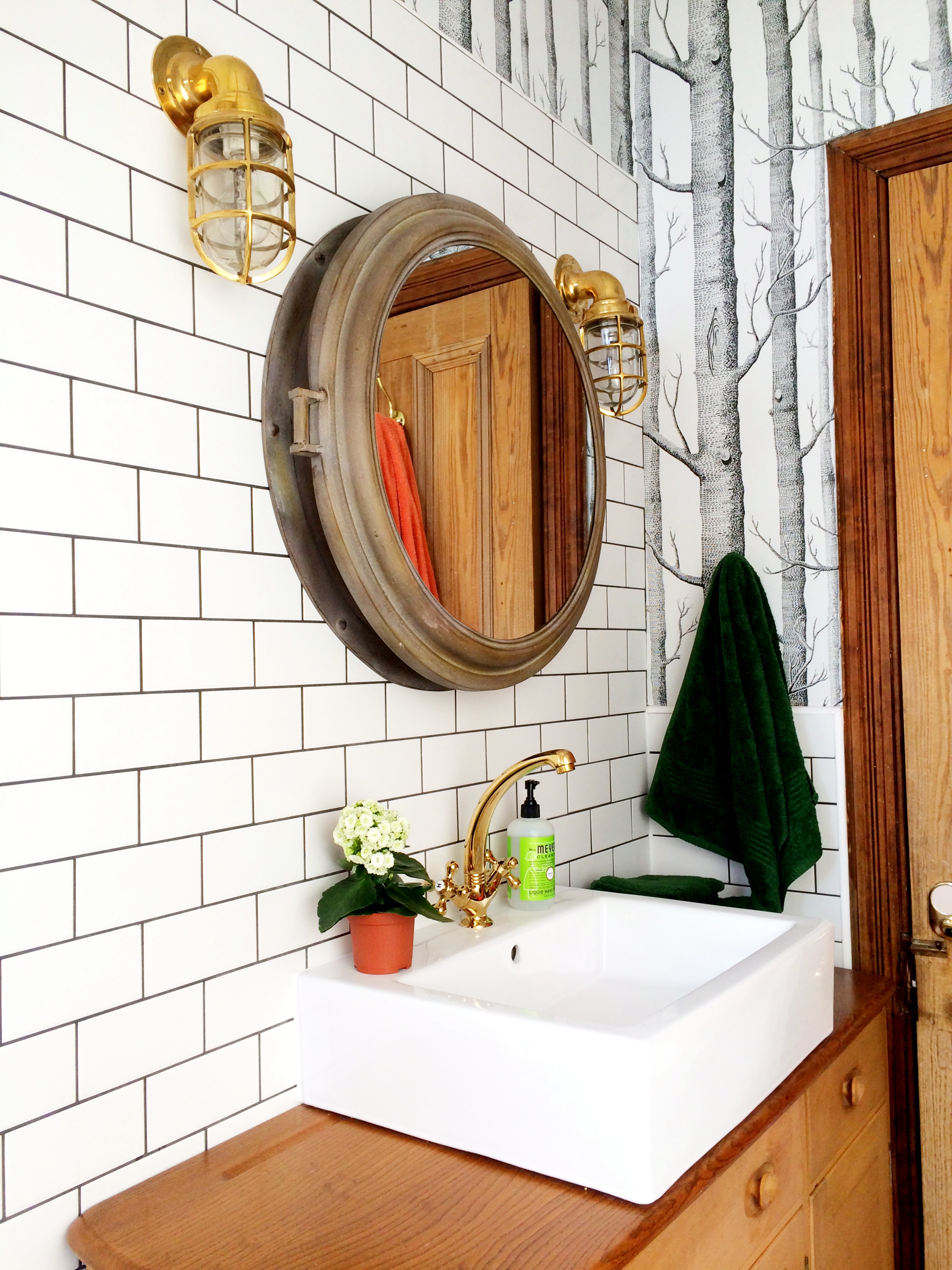 bathroom remodel; mirror; toilet; tile floor; shower; lighting; sink; wall art | Apartment remodeled by: Deborah Peterson Milne