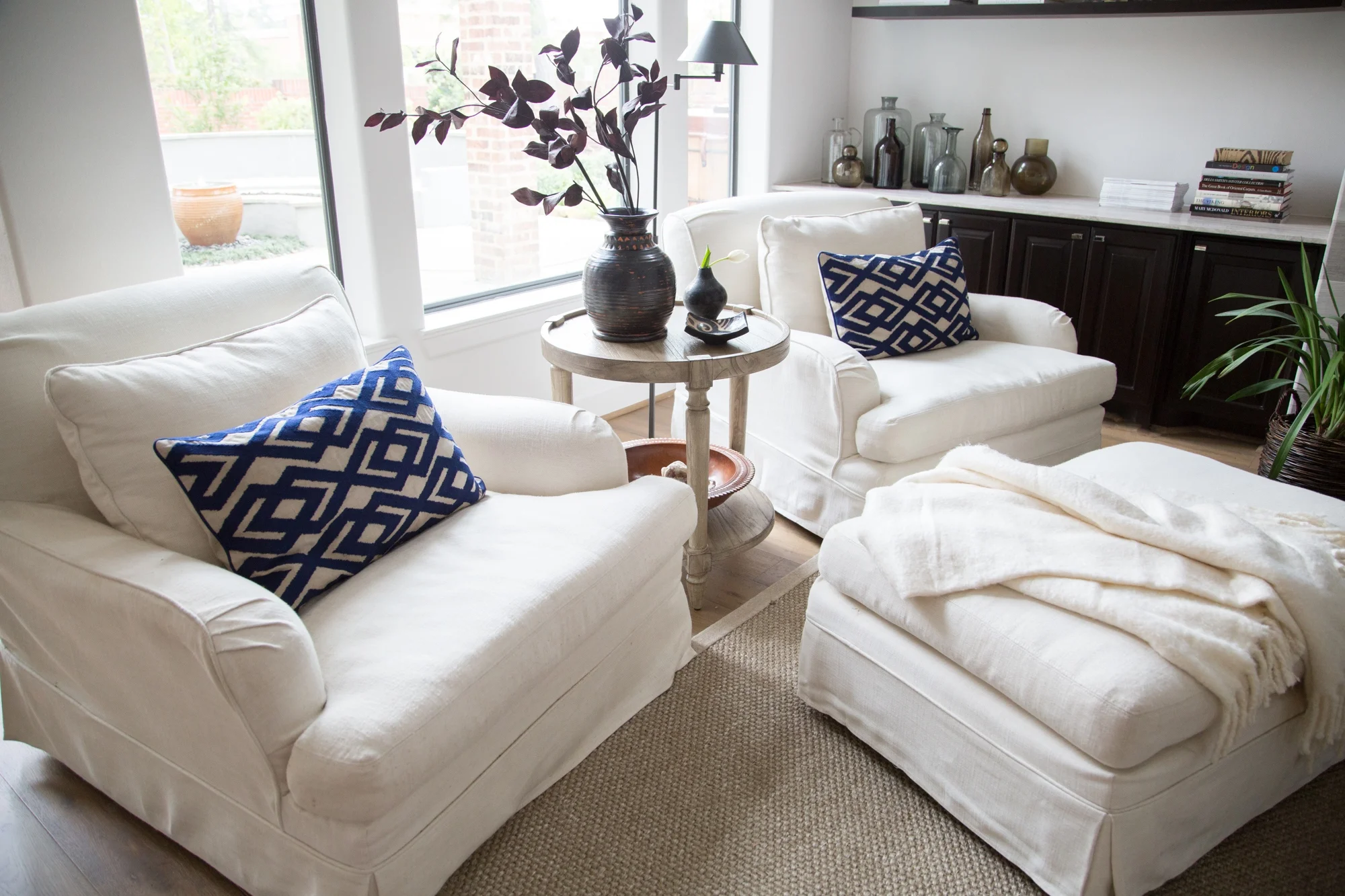  living room remodel; chair; Ottoman; table; shelving; decorative bottles | Interior Designer: Carla Aston / Photographer: Tori Aston