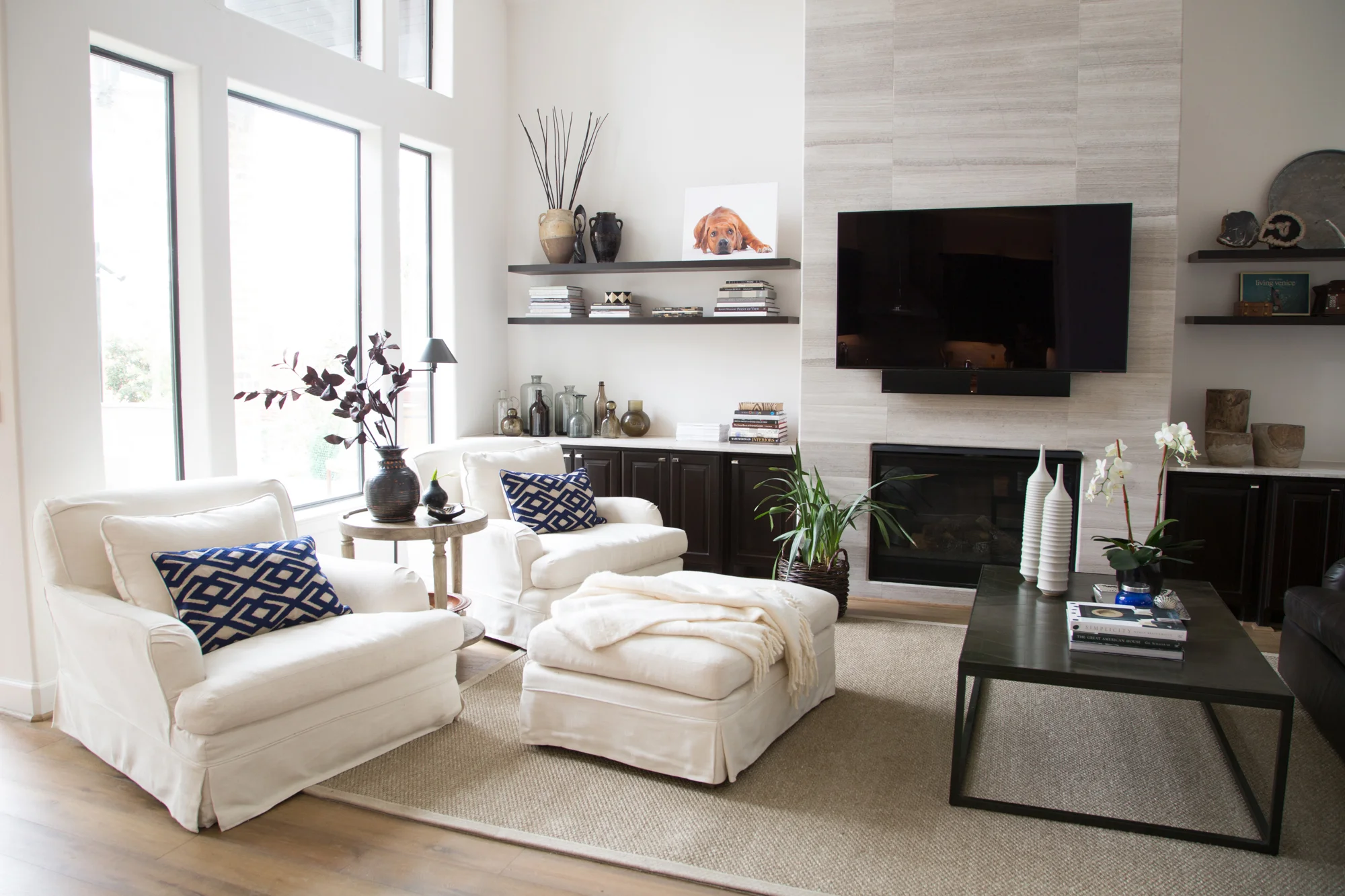  living room remodel; chair; Ottomans; leather sofa; shelving; fireplace; coffee table | Interior Designer: Carla Aston / Photographer: Tori Aston