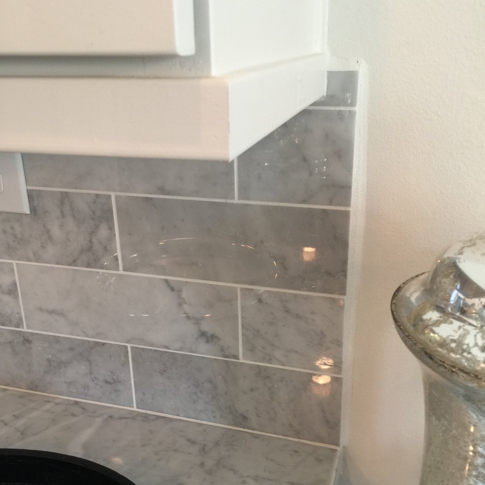 Tile installation seen in a builder model home - the tile backsplash just hangs in mid-air, looking unfinished.