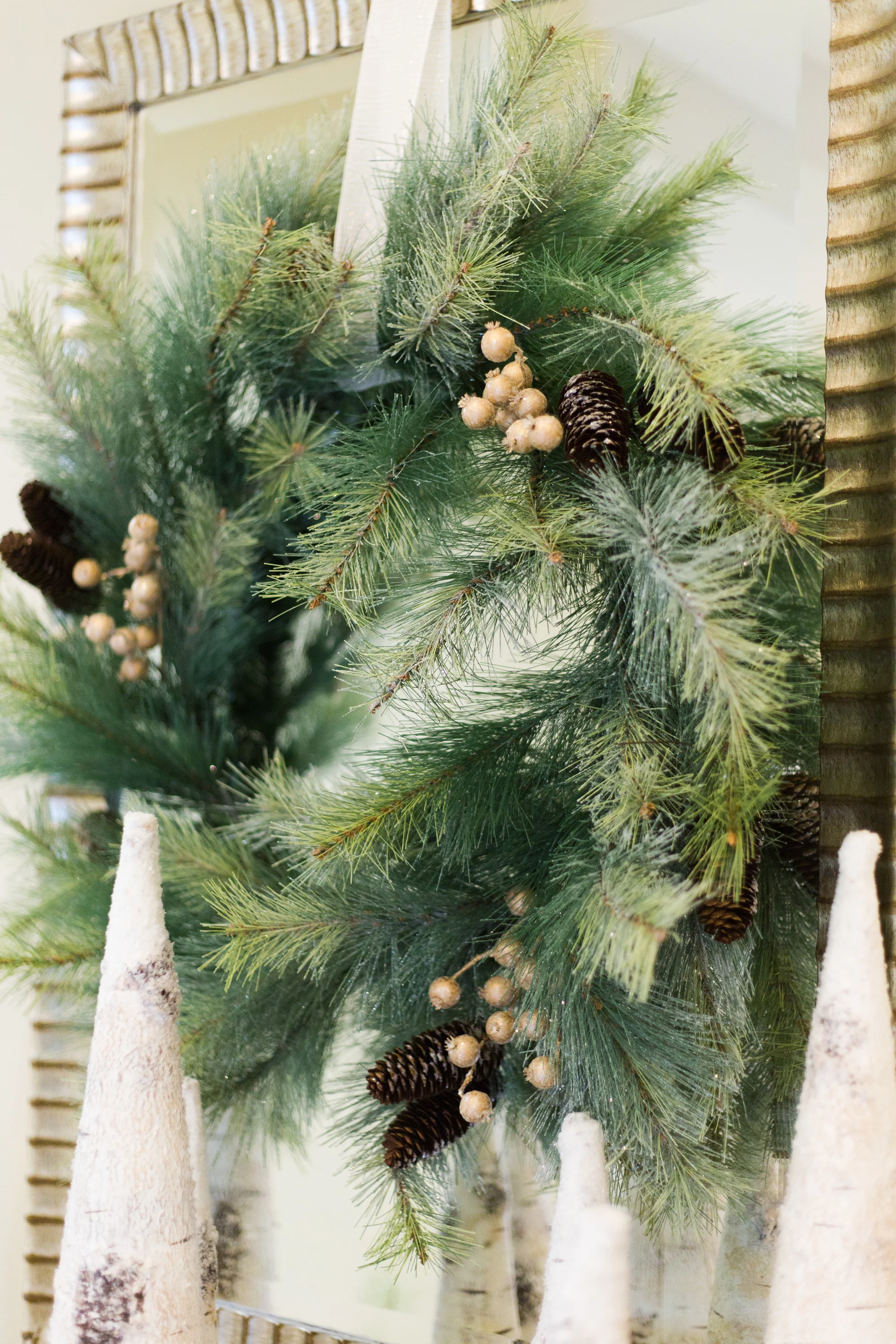 Simple holiday wreath with added gold berries hung on mirror #wreath #christmaswreath