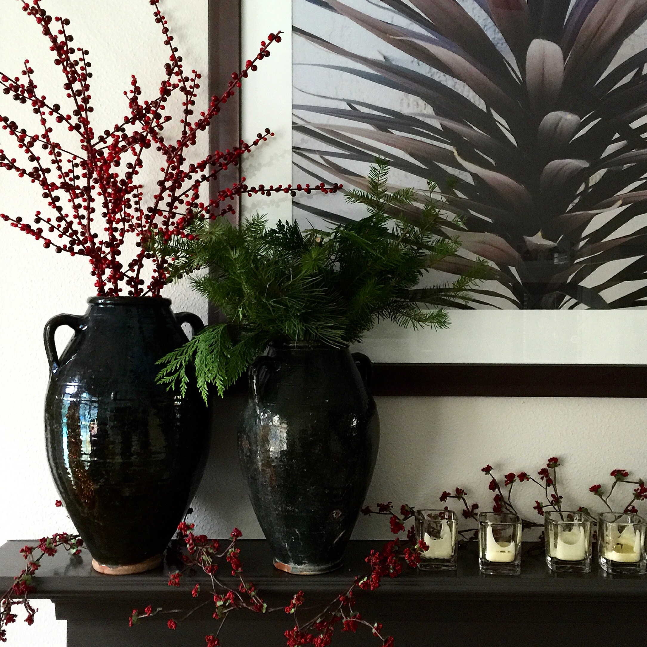 Rustic holiday mantel decor with antique olive jars