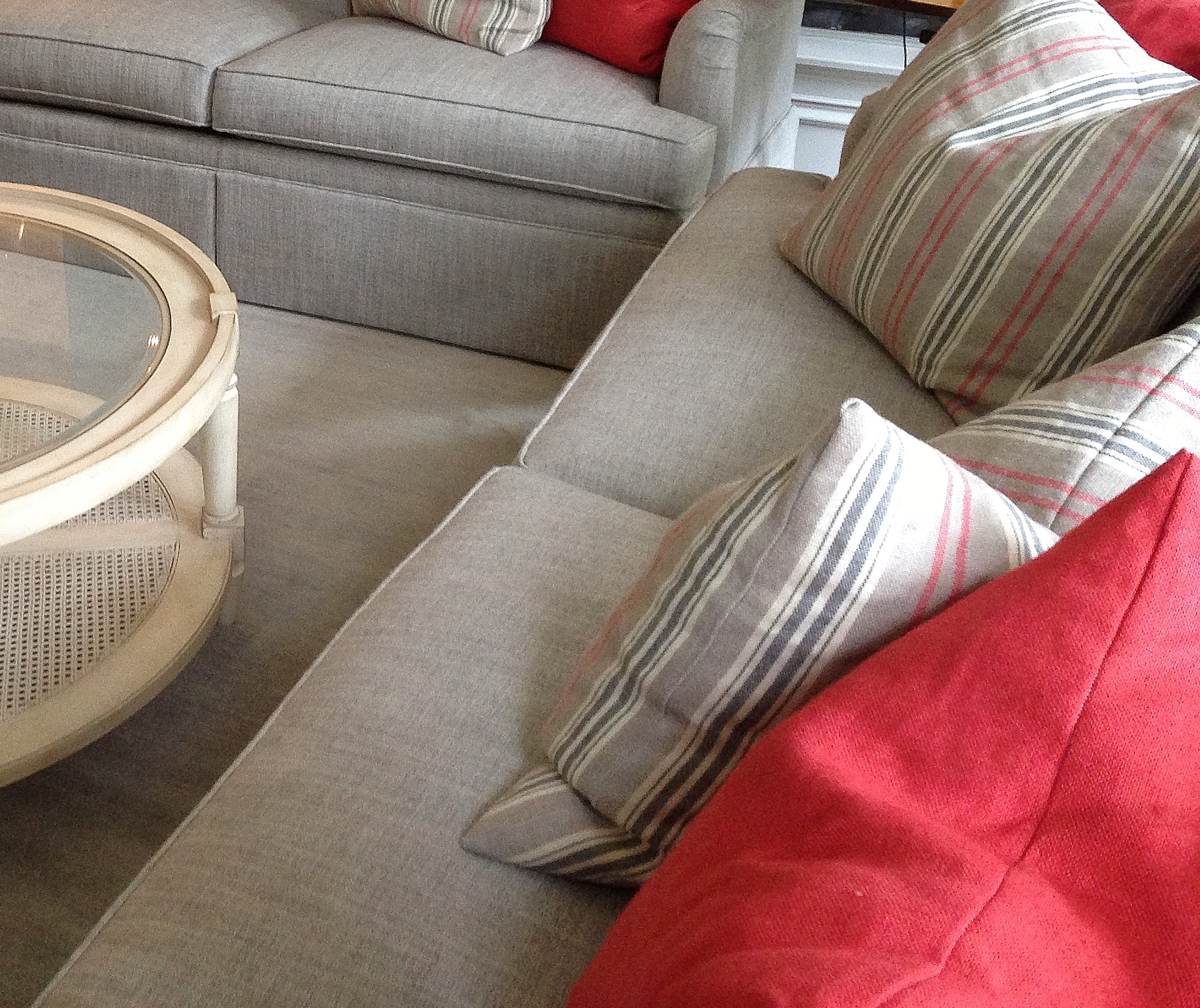 Coral pillows in a neutral gray room