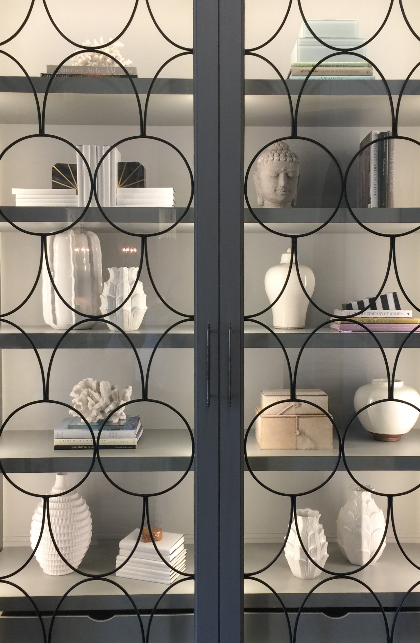 Glass front bookcases in the family room designed by Tami Owen of The Owen Group
