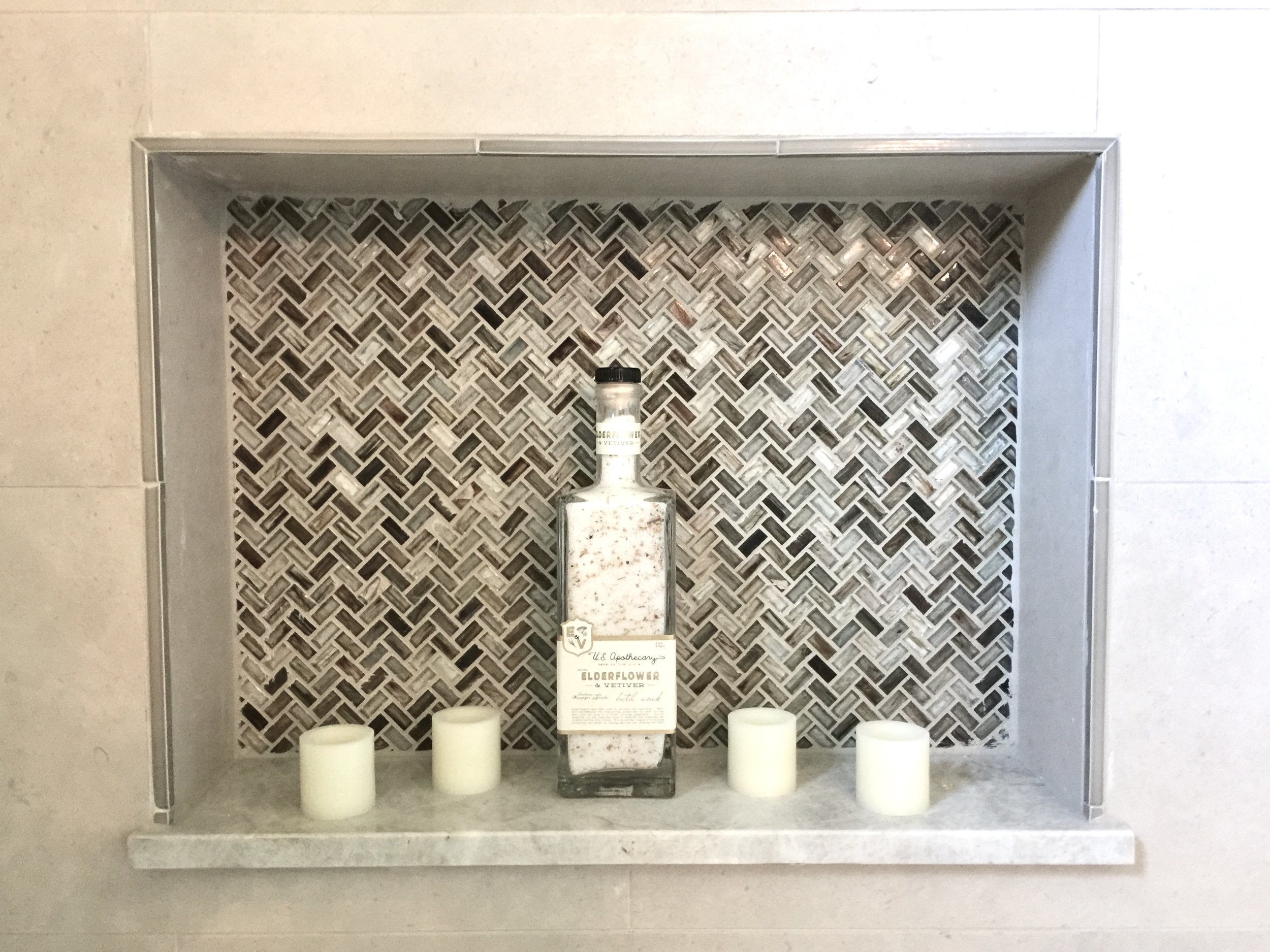 Shampoo niche with marble shelf in bathroom designed by Cristina Robinson