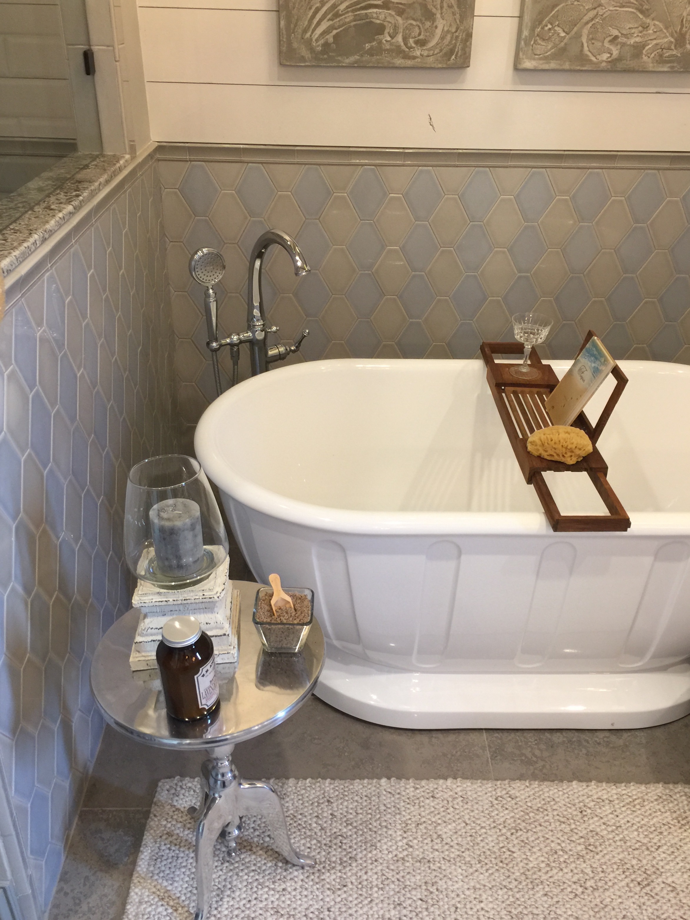 Gray and beige tile mixed in the bathroom with shiplap wall designed by Christina Mullen