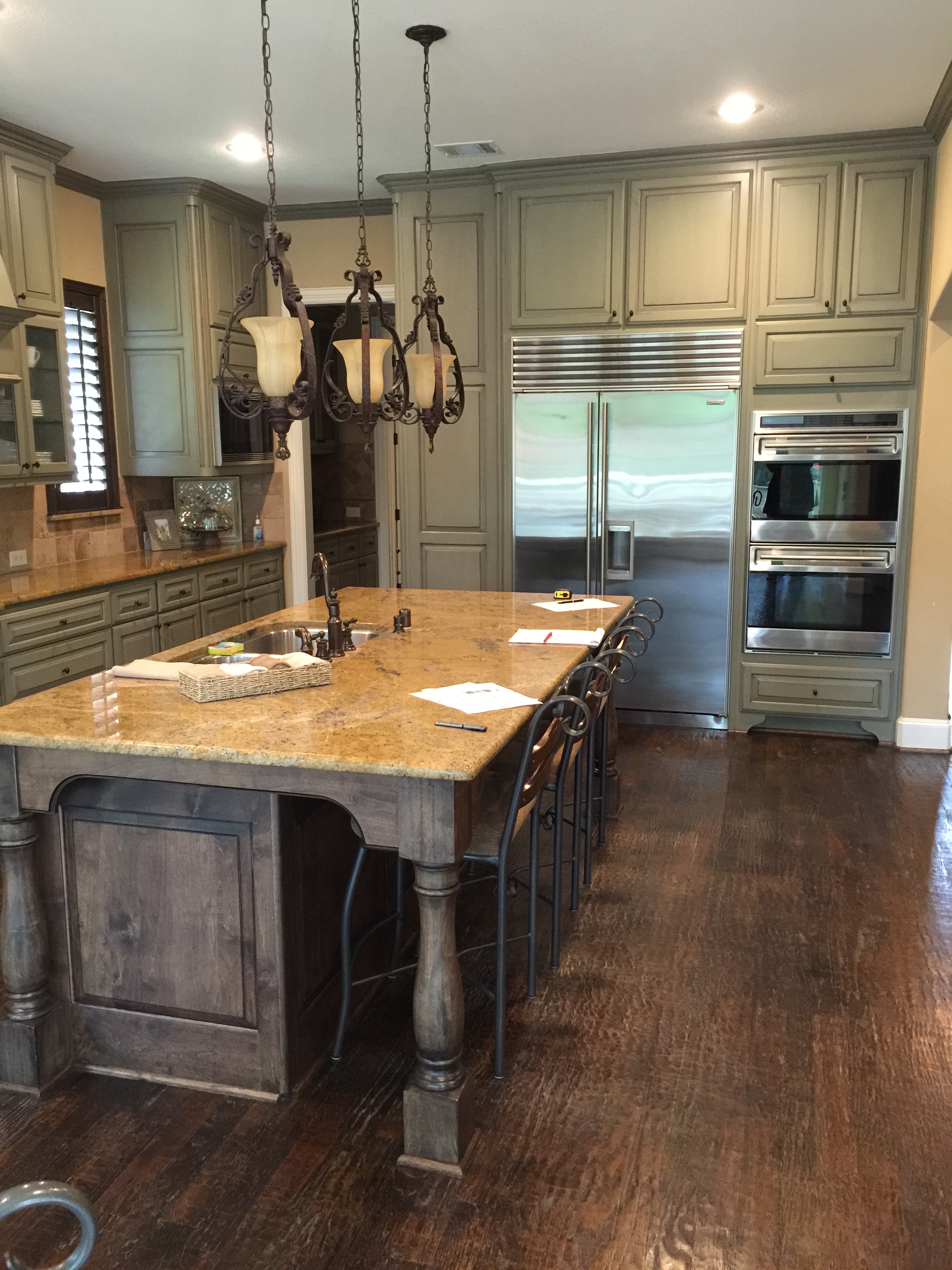 Before kitchen remodel with sage green cabinets and spotty gold granite