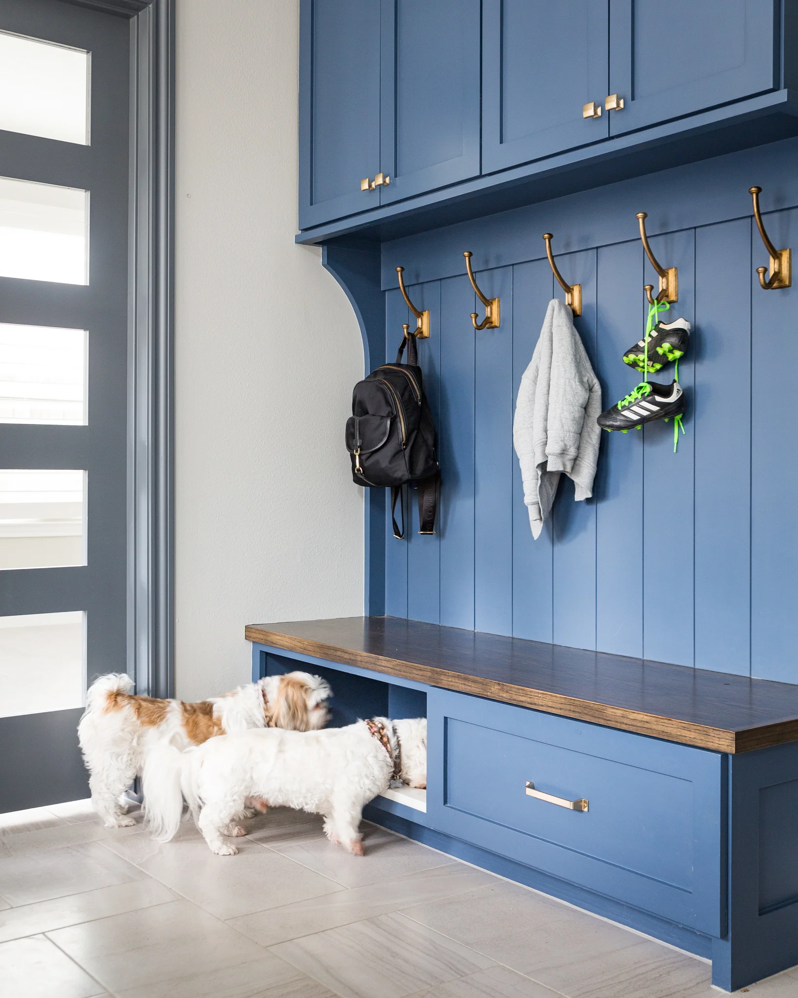 BEFORE AND AFTER - A navy and white kitchen remodel w/ mudroom bench, dog feeding station | Carla Aston, Designer | Colleen Scott, Photographer #mudroom #dogbowl #bench #cabinetry