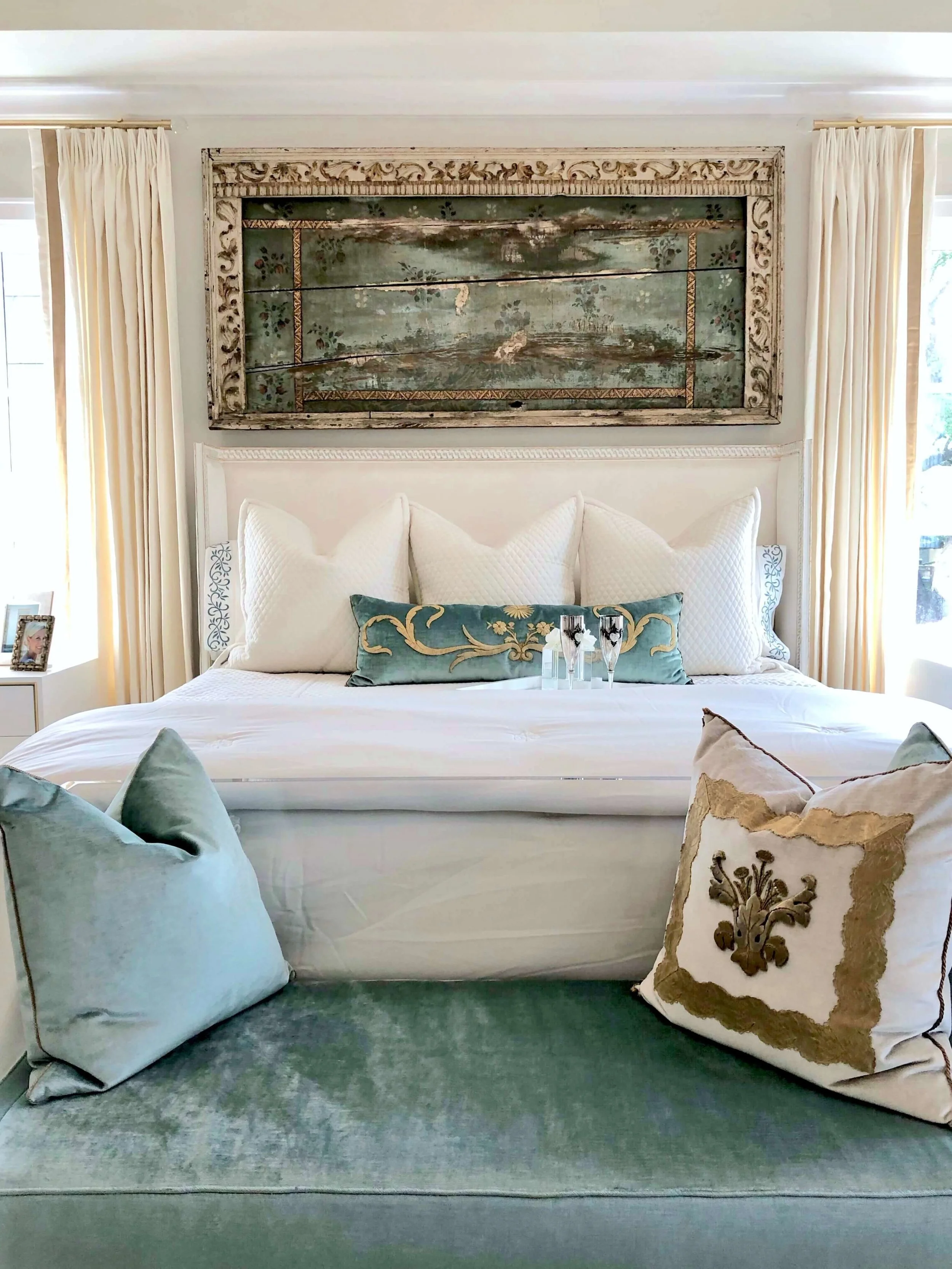 The luxurious master bedroom was designed in soft turquoise and white with plush white bedding by Teena Caldwell of Twenty-Two Fifty Interiors. | ASID River Oaks Showhouse #masterbedroom #whitebedding #bedroomdesign