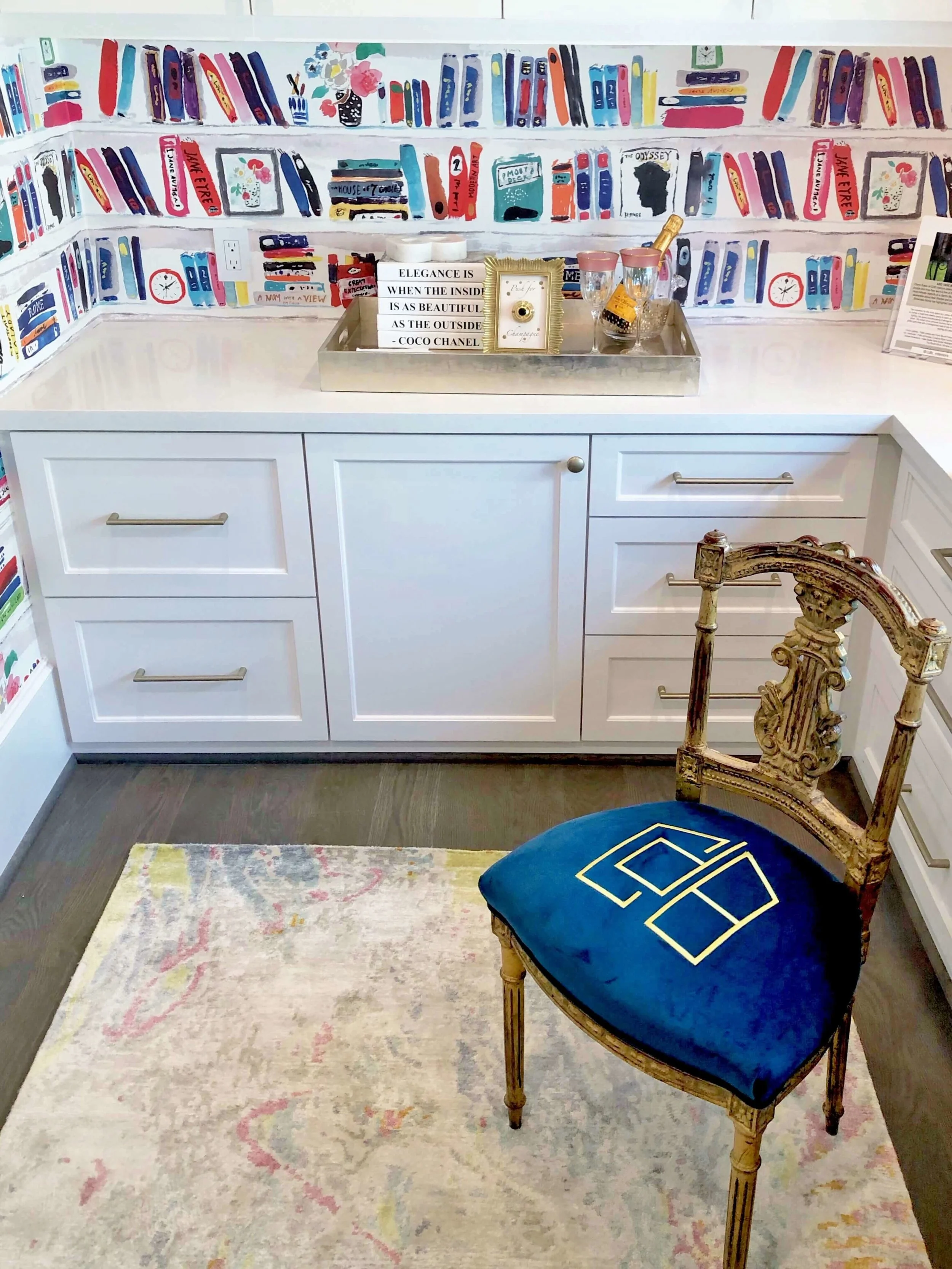 A small monogrammed antique chair adds the perfect touch to the brightly colored wallpapered home office, designed by Cheryl Baker of CDB Interiors. | ASID River Oaks Showhouse #homeoffice #katespade #wallpaper