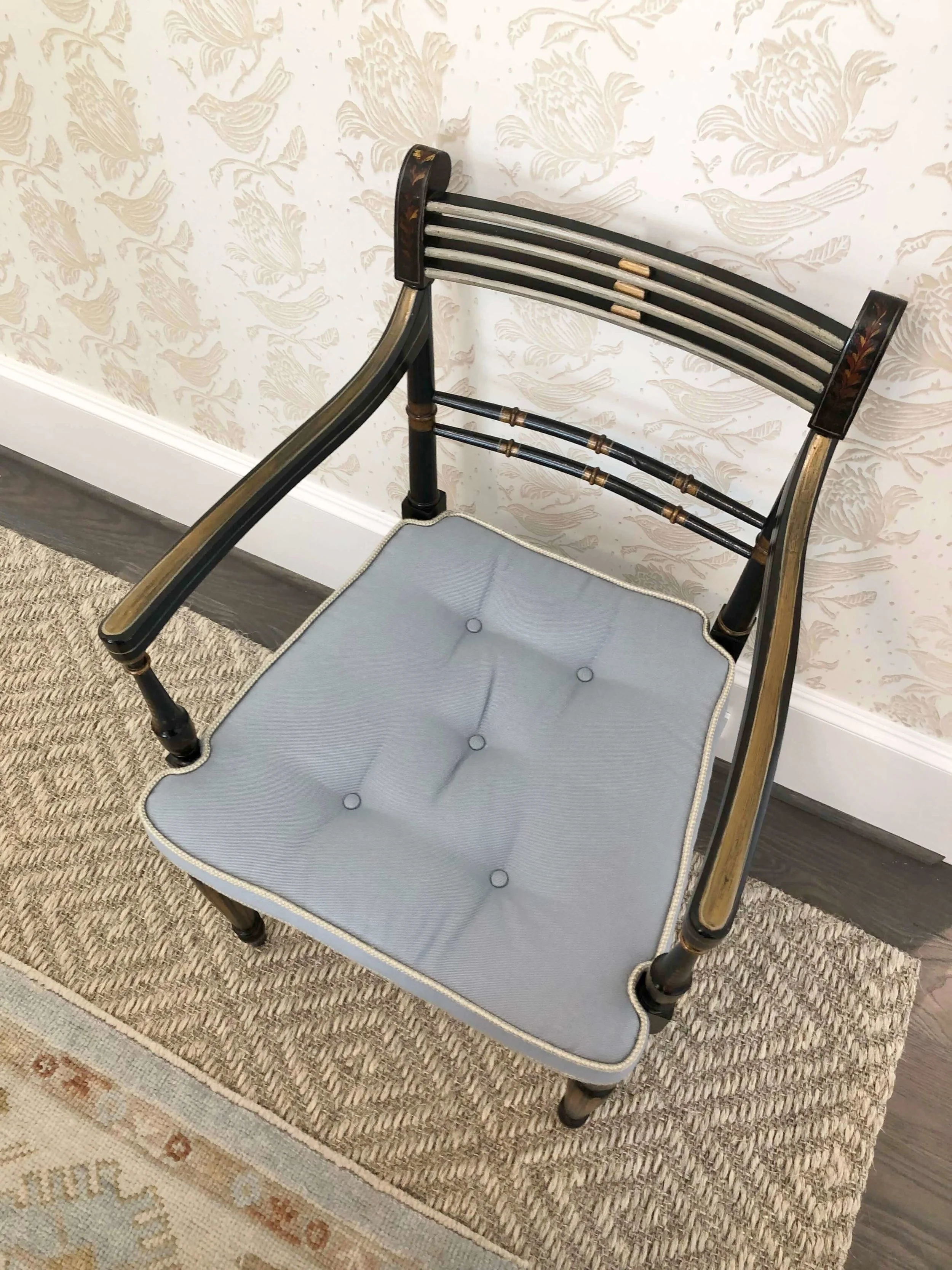 Love the textures here with the layered rugs and tone on tone neutral wallpaper in this guest bedroom designed by designer, Sherrell Neal, Sherrell Design Studio | ASID River Oaks Showhouse #antiquechair #seagrassrug #neutralbedroom #wallpaper