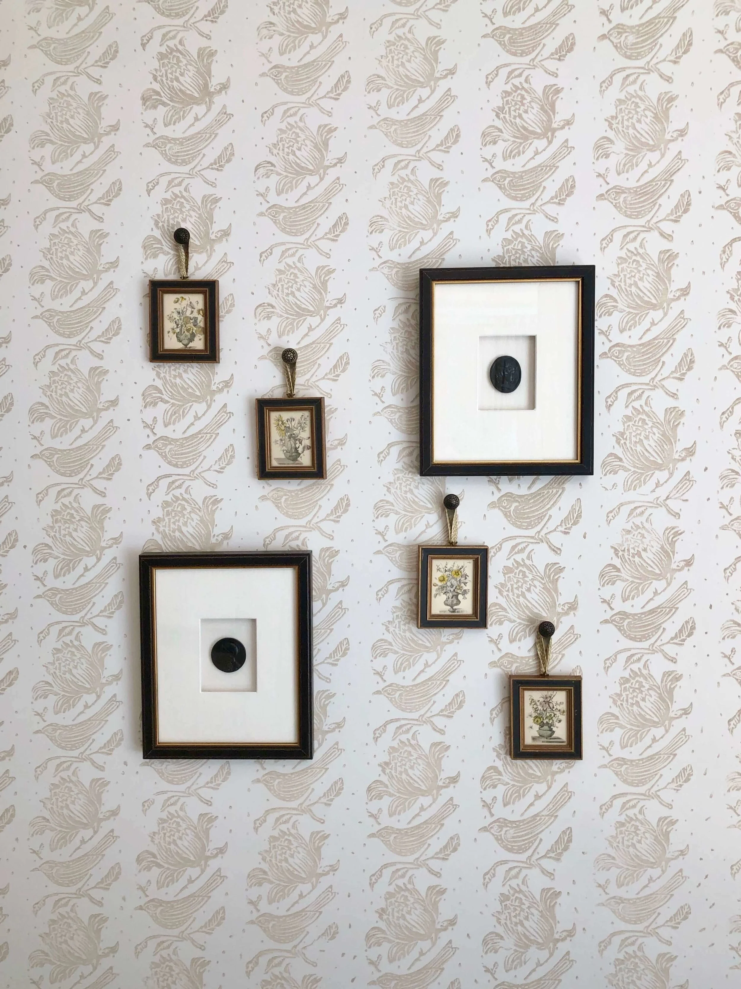 Sweet wall decor dressed the walls that were adorned with a subtly patterned walls in the guest bedroom. Designer, Sherrell Neal, Sherrell Design Studio | ASID River Oaks Showhouse #wallpaper #neutralbedroom