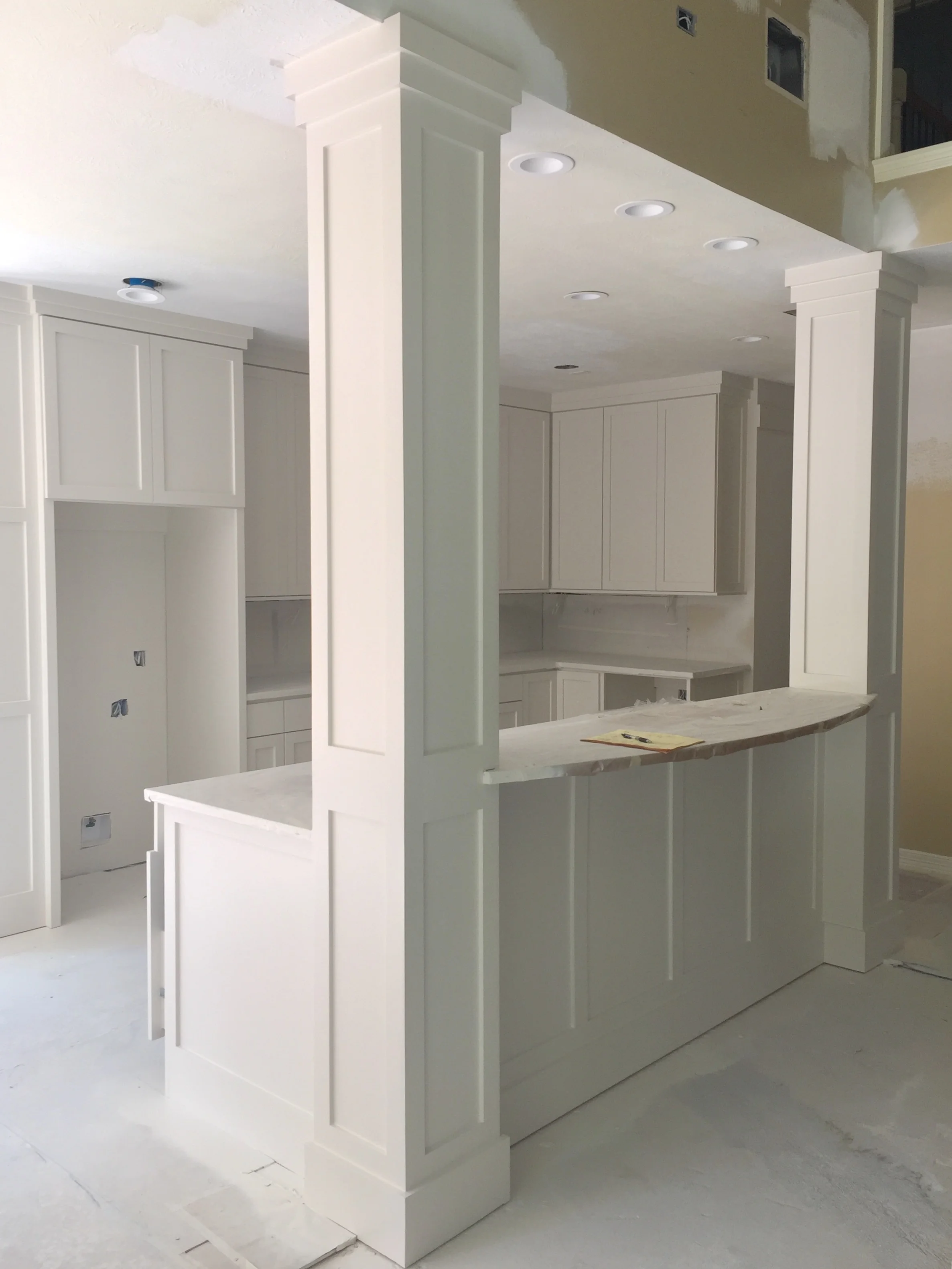 IN PROGRESS - Here the bar paneling is complete and primed, ready for paint. I often will do a slight eyebrow arch on the bar counter to soften the corners and add a bit of extension to the bar.