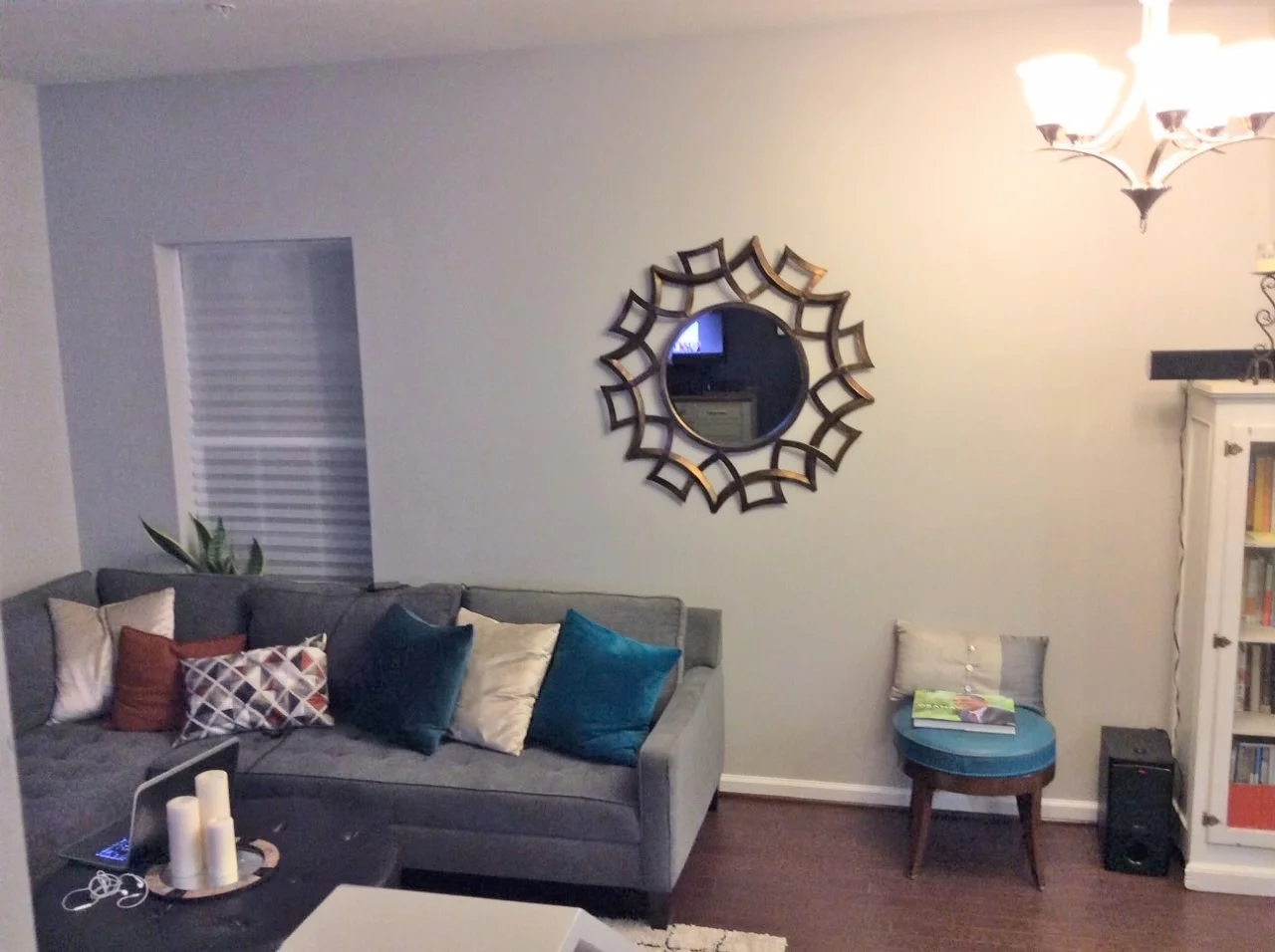 Before - living room with awkward placement of wall decor and furnishings