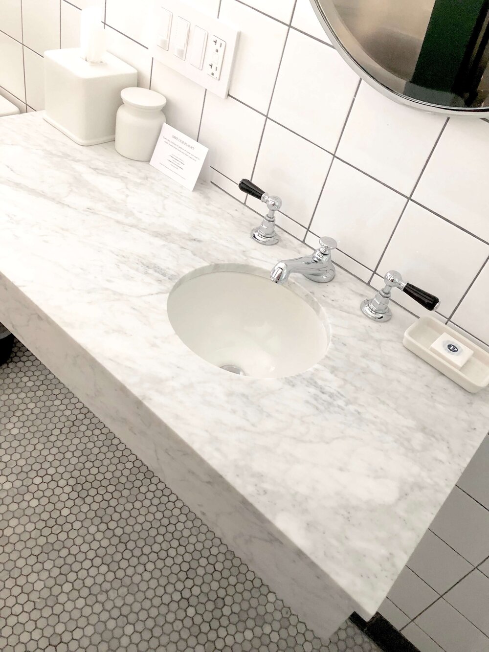 Small Bathroom Design Tips - Hotel bathroom with Carrara marble countertop and small round sink.