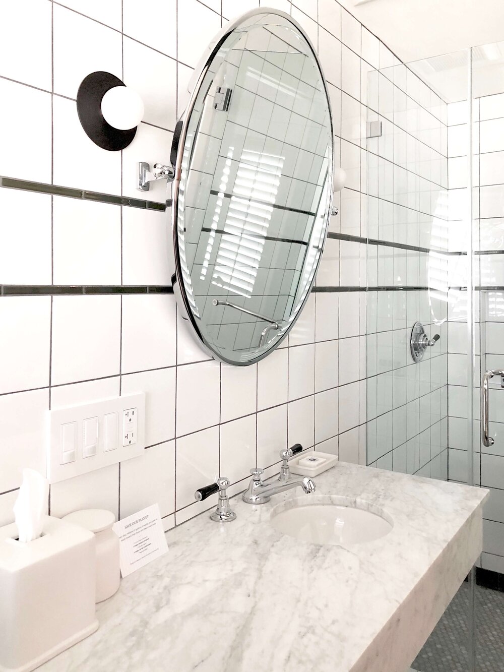 Small Bathroom Design Tips - Hotel bathroom with Carrara marble countertop and small round sink.