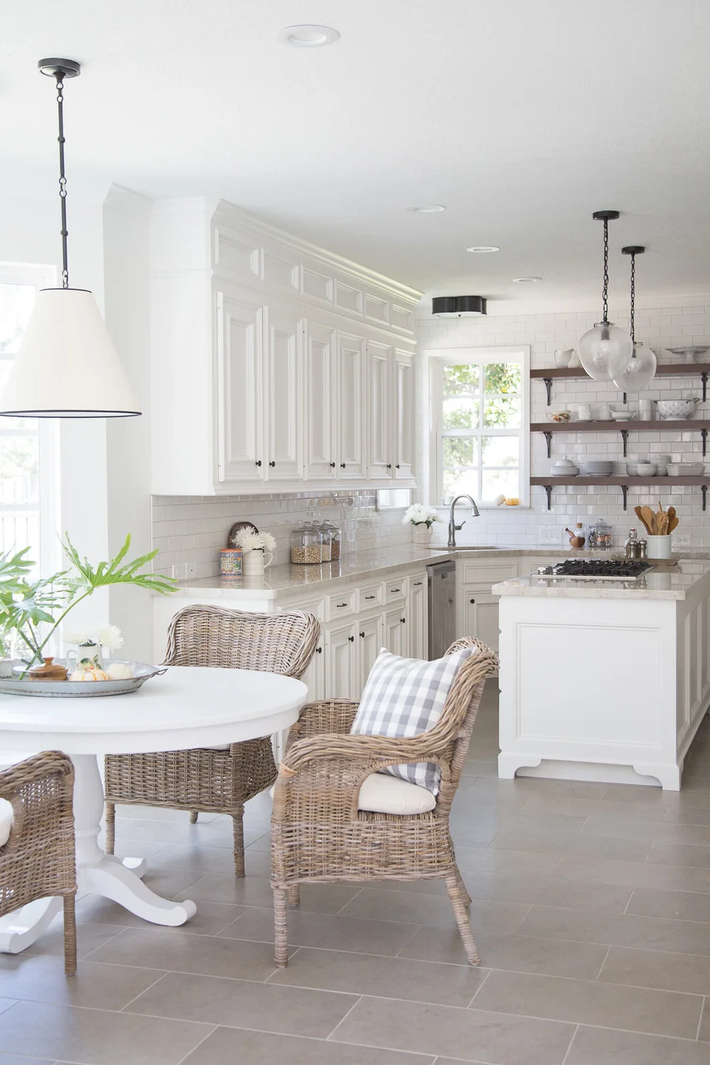Wood open shelves add interest in this white kitchen. | Designer, Carla Aston | Photographer, Tori Aston #whitekitchen