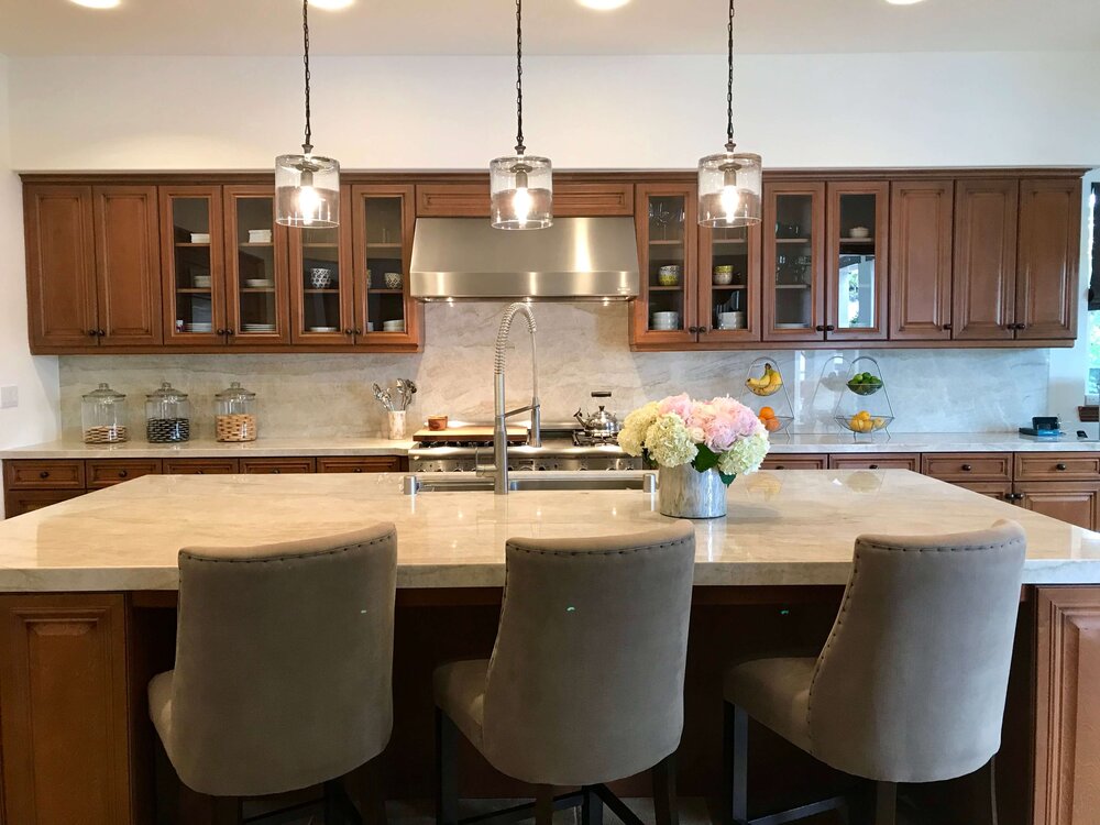 Kitchen with new Taj Mahal countertops and splash that was open to the family room and fireplace wall.